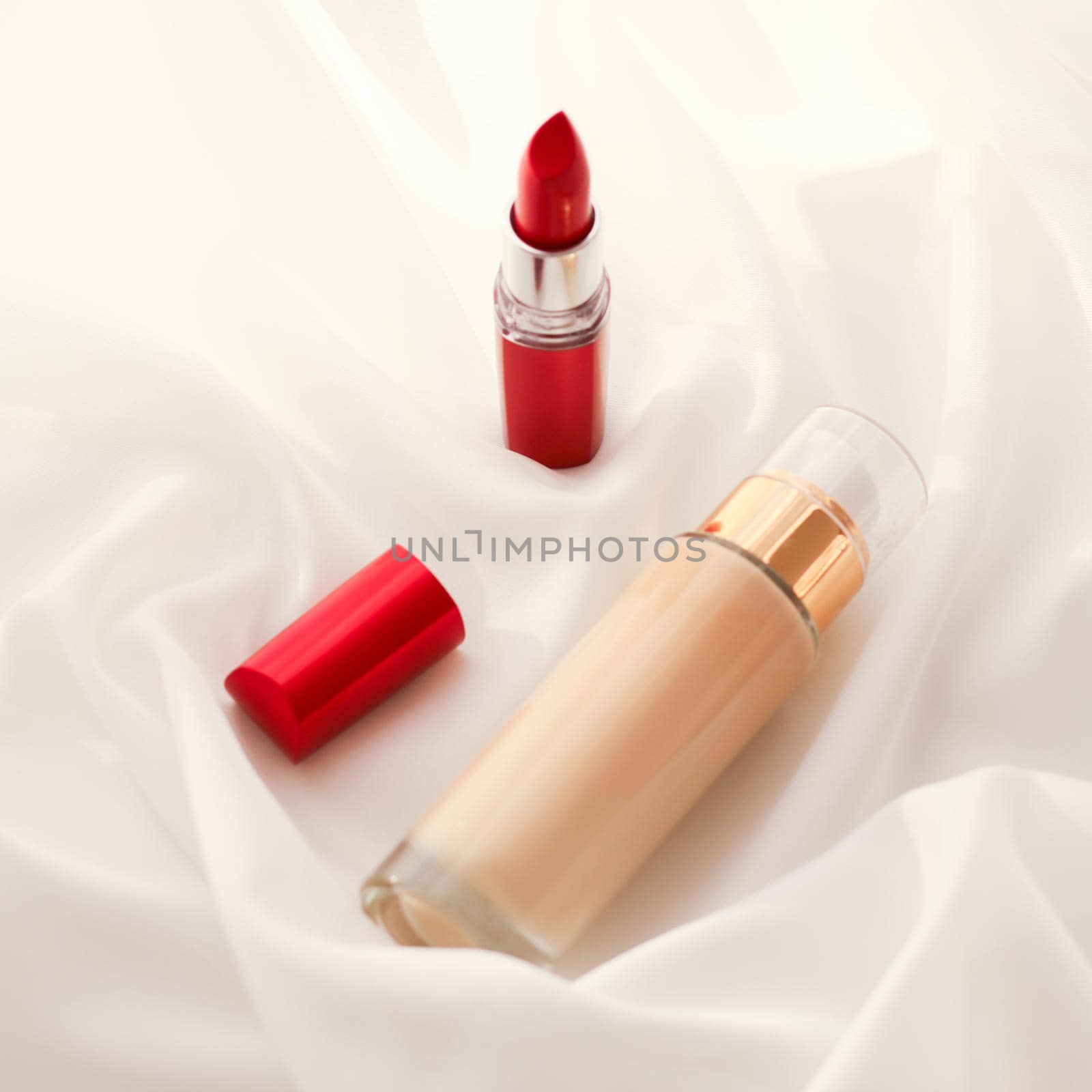 Cosmetic branding, glamour and skincare concept - Beige tonal cream bottle make-up fluid foundation base and red lipstick on silk background, cosmetics products as luxury beauty brand holiday design