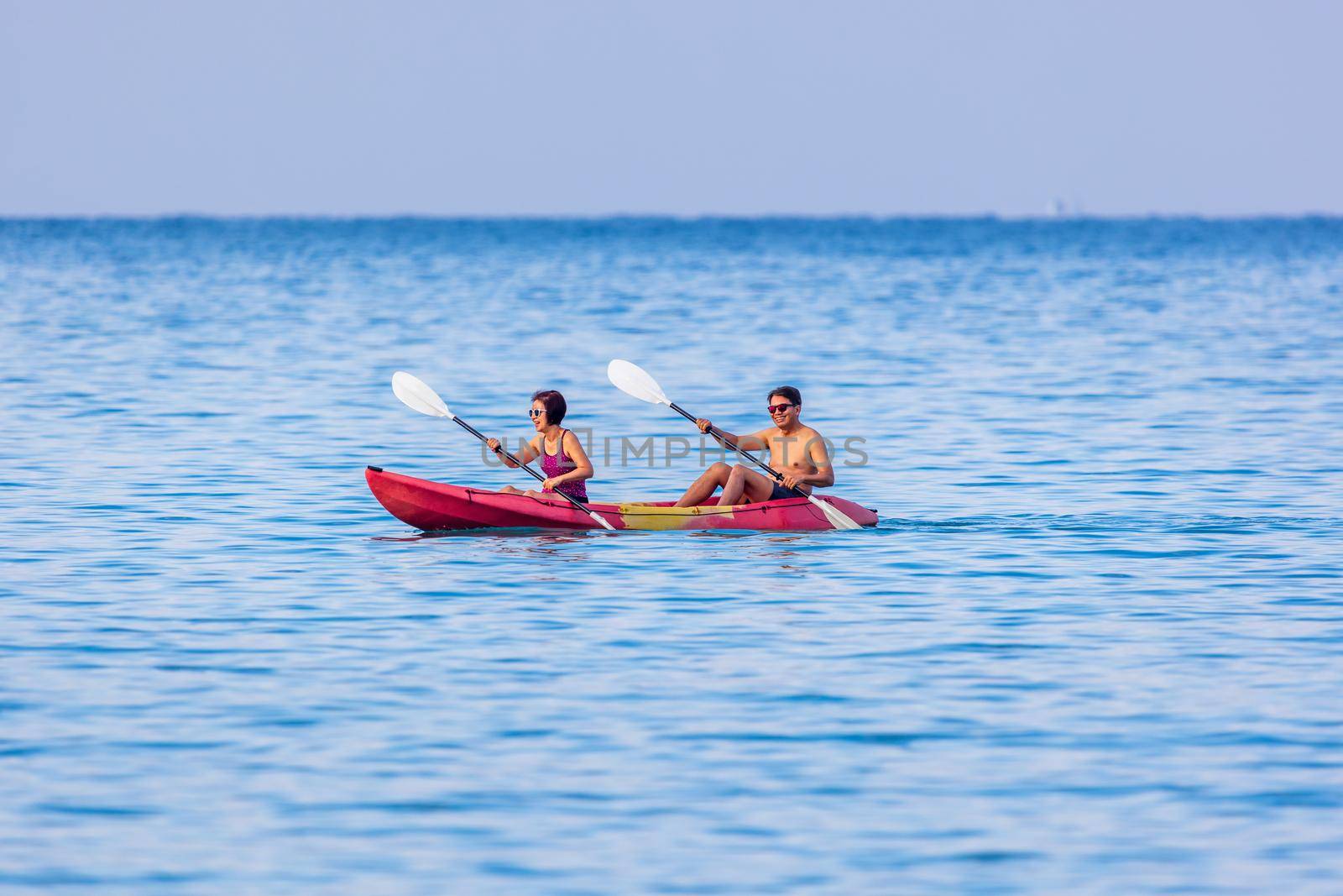 Asian middle aged couple on kayak in adventure travel in south east asia. by toa55