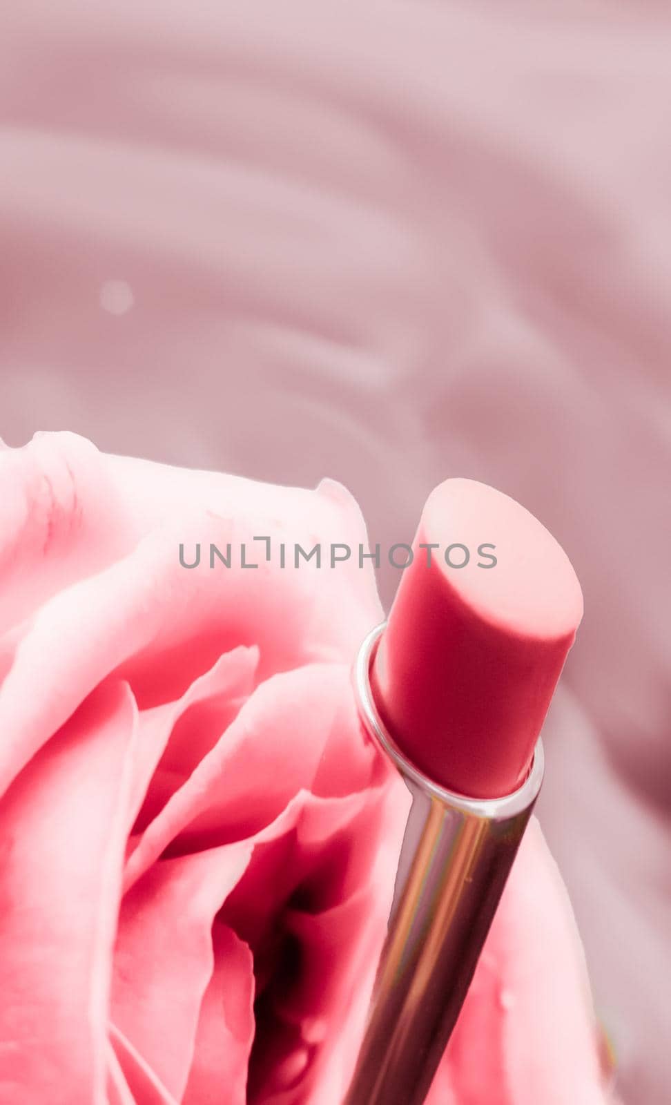 Cosmetic branding, luxe and fashion concept - Pink lipstick and rose flower on liquid background, waterproof glamour make-up and lip gloss cosmetics product for luxury beauty brand holiday design