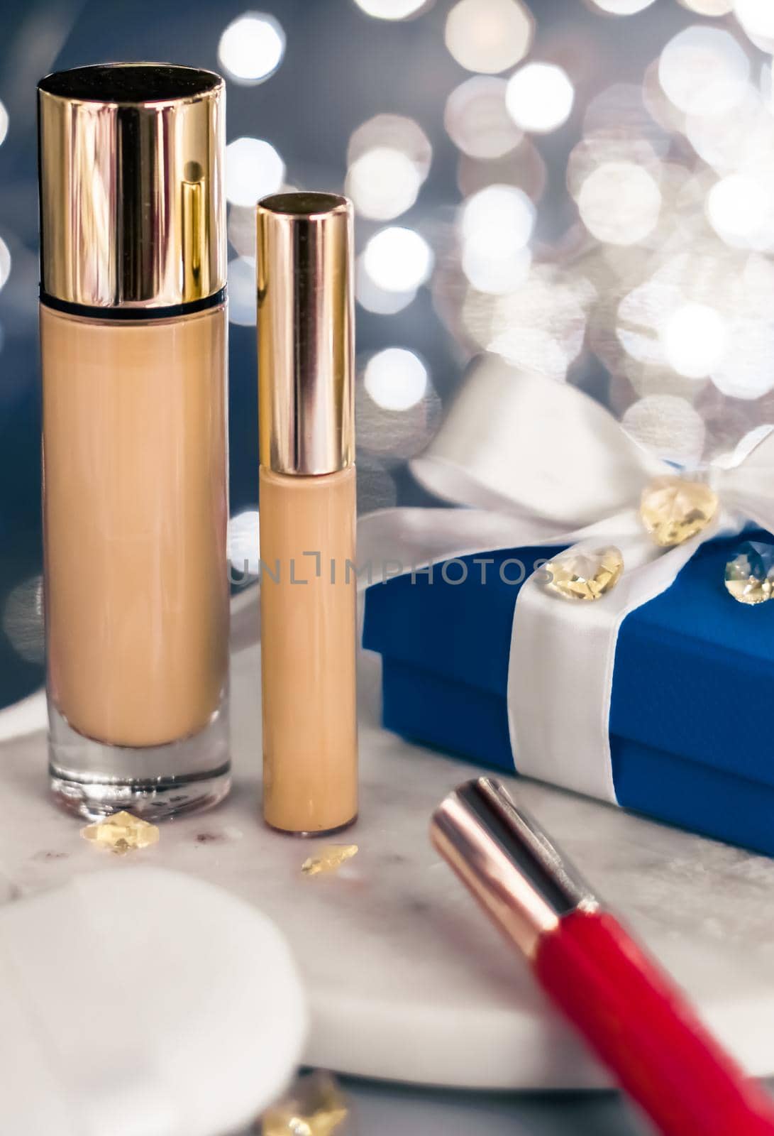 Cosmetic branding, Christmas glitter and girly blog concept - Holiday make-up foundation base, concealer and blue gift box, luxury cosmetics present and blank label products for beauty brand design