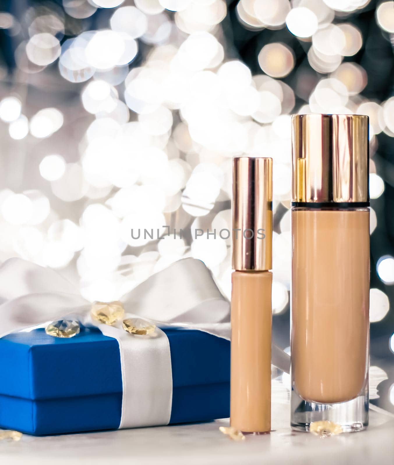 Cosmetic branding, Christmas glitter and girly blog concept - Holiday make-up foundation base, concealer and blue gift box, luxury cosmetics present and blank label products for beauty brand design