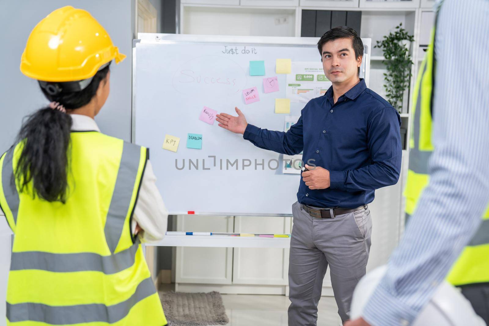 A team of investor and competent engineers brainstorming on the whiteboard to find new ideas and making plans. The idea of a team gather ideas together.