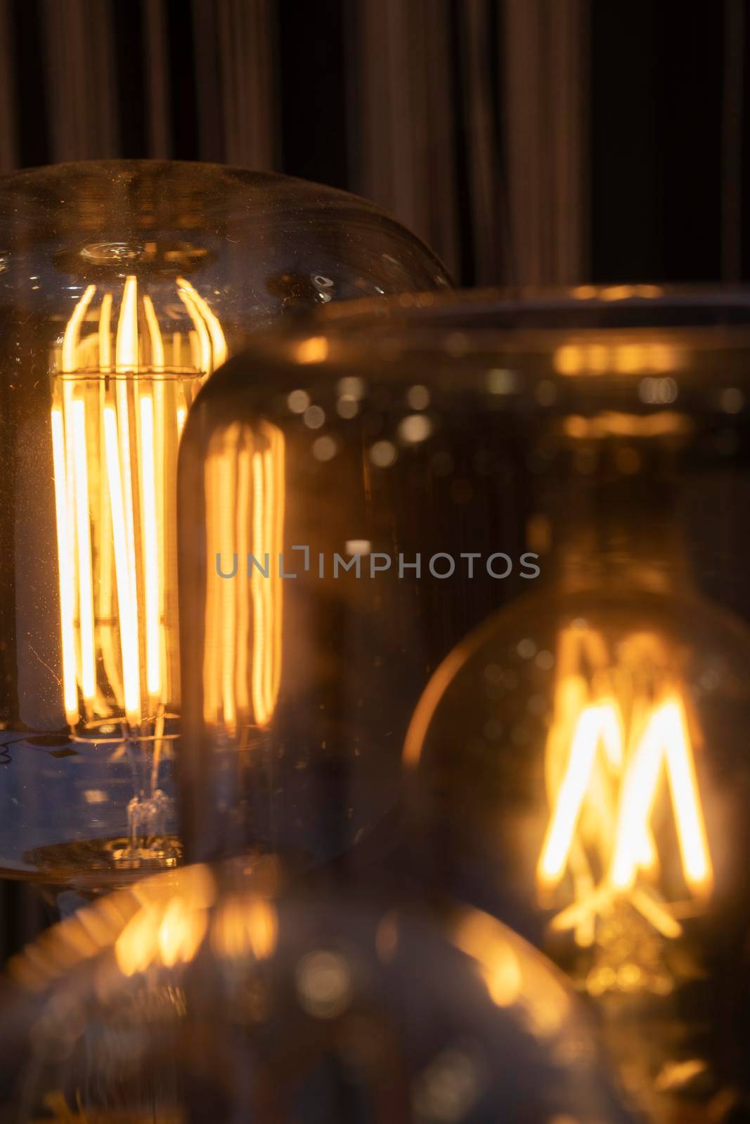 Close up several yellow warm lamp in cafe at night by papatonic