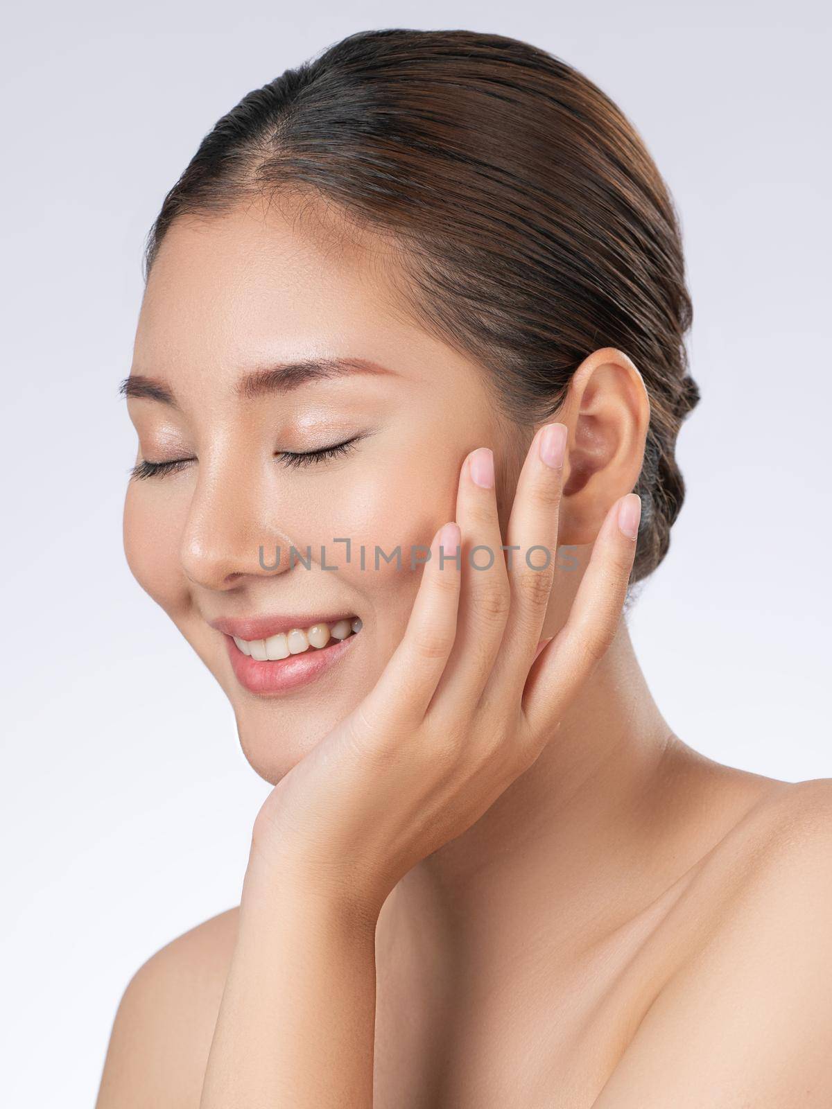 Portrait of gorgeous young girl posing beauty gesture with clean fresh skin. by biancoblue