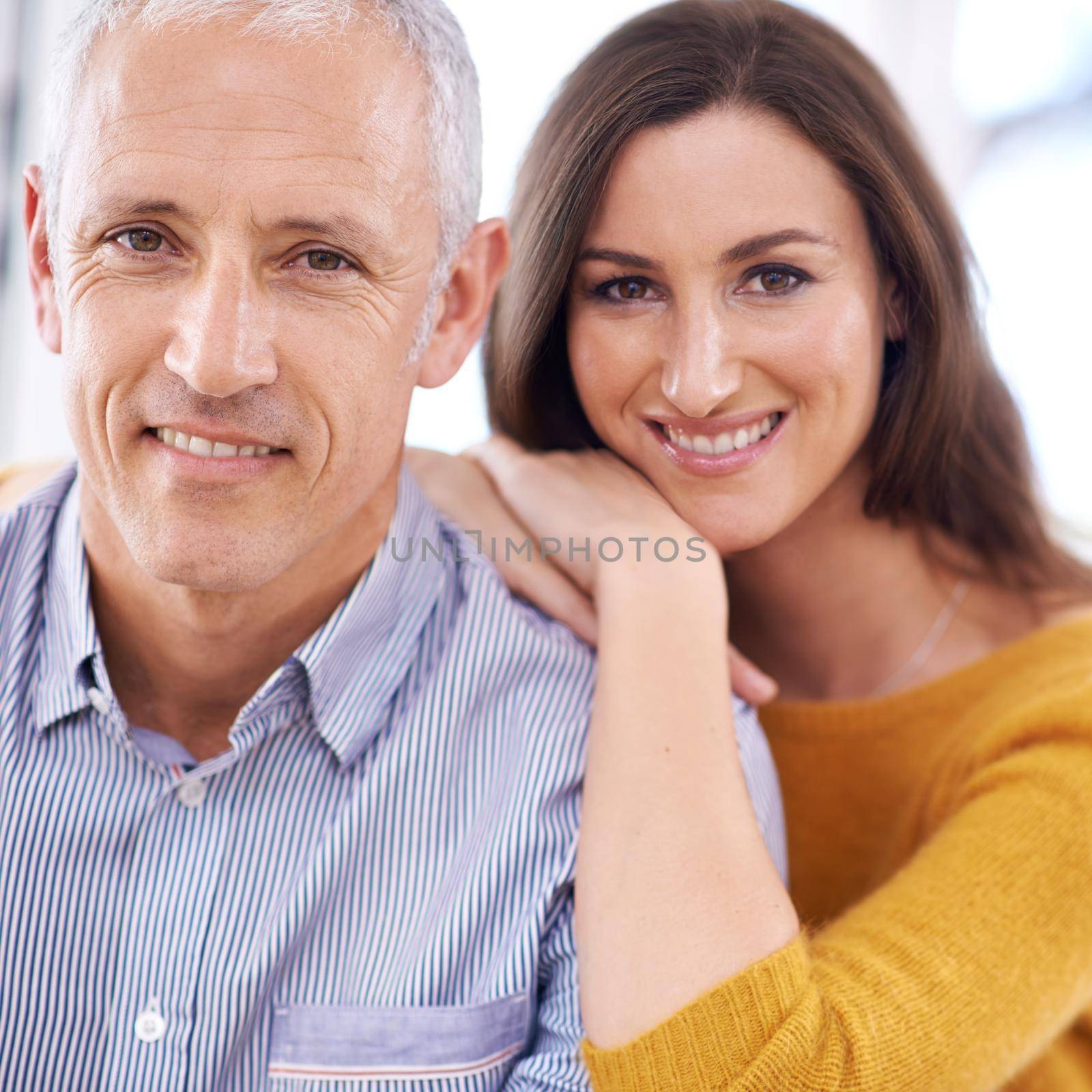 Happy at home together. a young woman being affectionate towards her older husband. by YuriArcurs