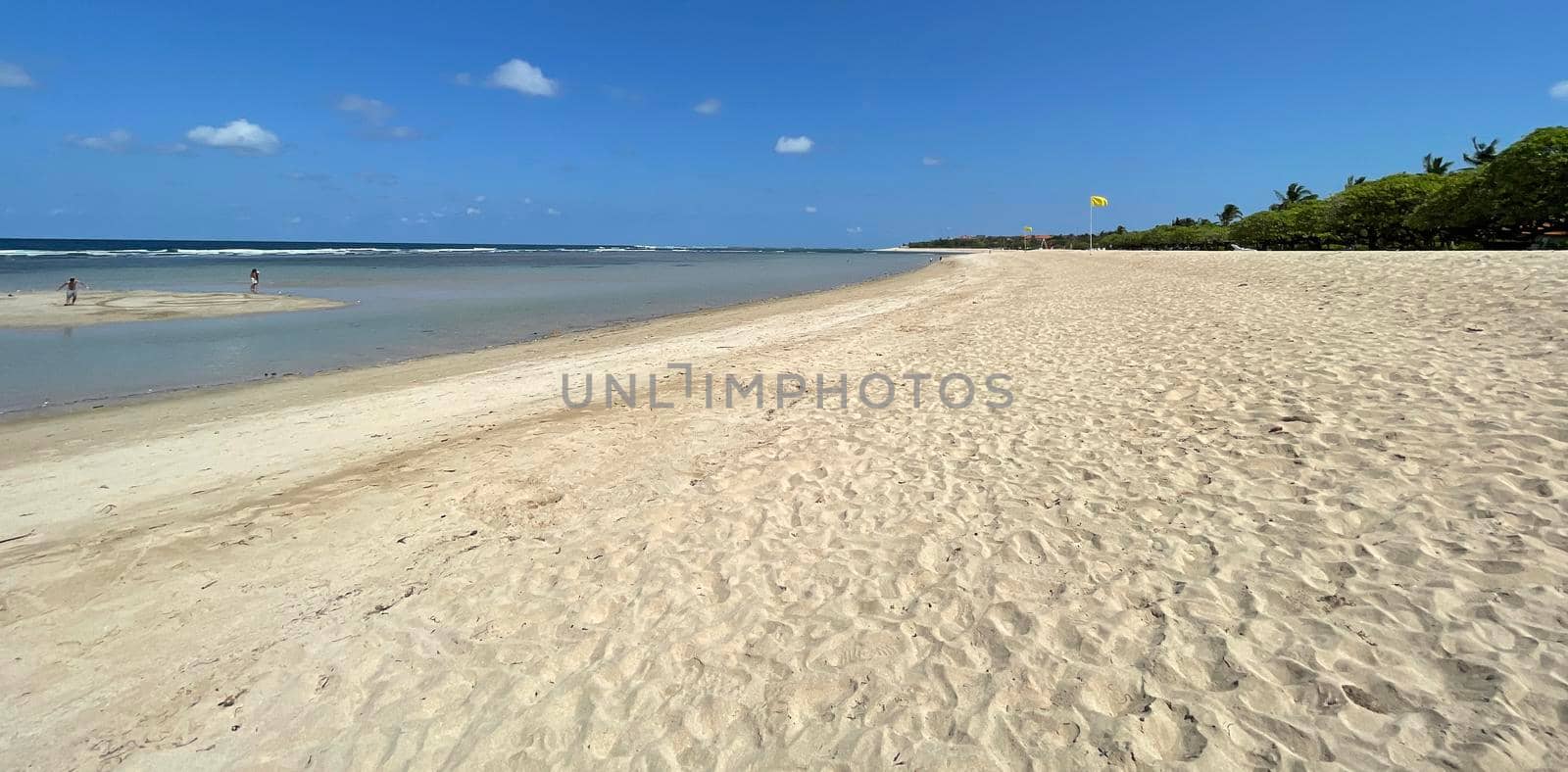 Tropical beach in sunny weather with blue sky and white sands Panorama of a beautiful white sand beach and turquoise water, Holiday summer beach background Wave of the sea on the sand beach