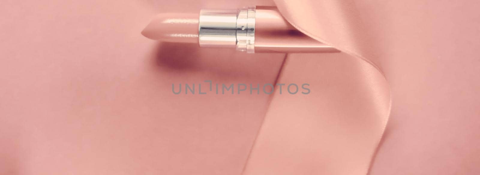 Cosmetic branding, glamour lip gloss and shopping sale concept - Luxury lipstick and silk ribbon on blush pink holiday background, make-up and cosmetics flatlay for beauty brand product design