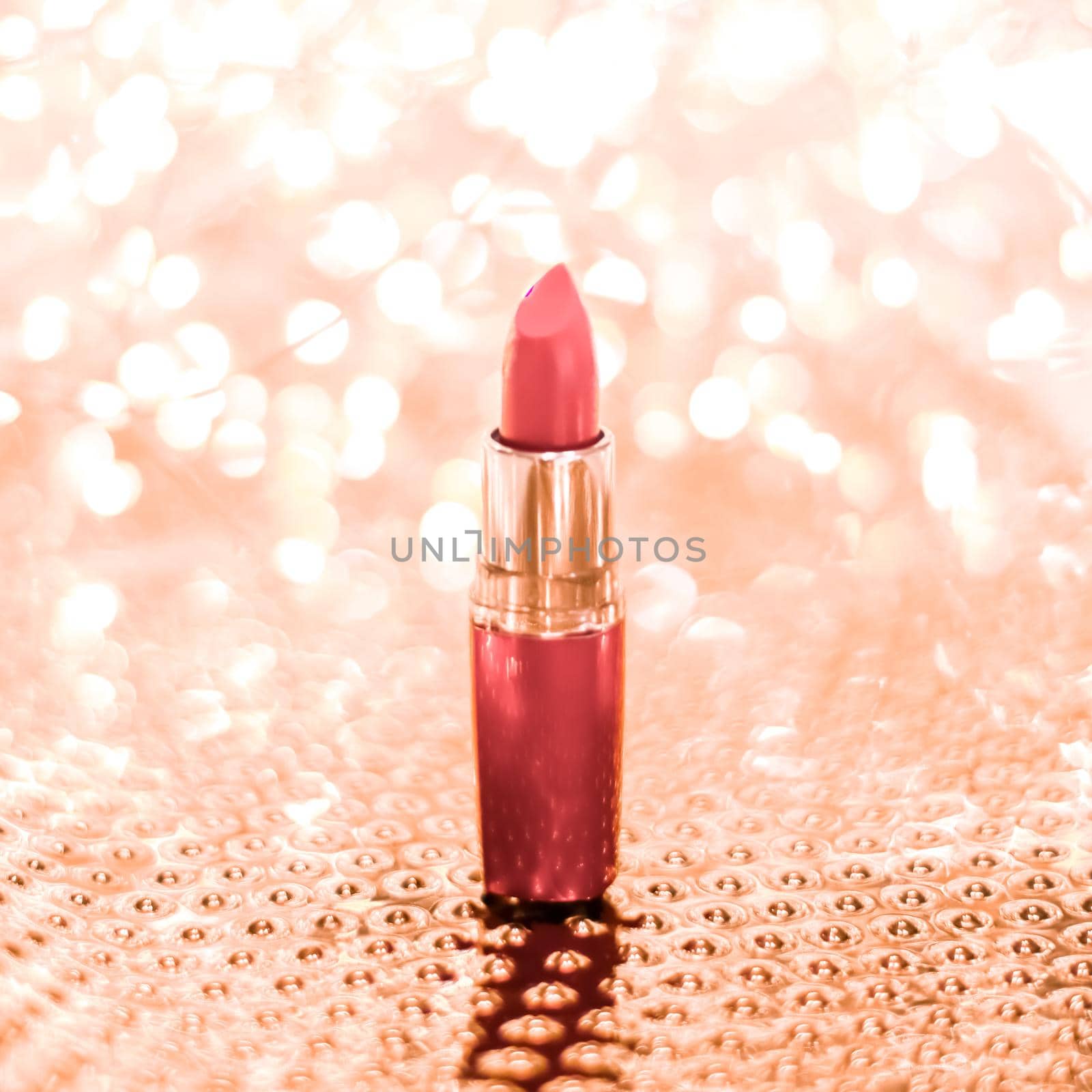 Coral lipstick on rose gold Christmas, New Years and Valentines Day holiday glitter background, make-up and cosmetics product for luxury beauty brand by Anneleven