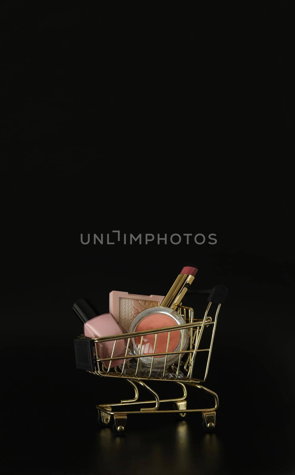 Shopping trolley full of make up and cosmetic goods on black background. Black friday concept. Sale and discount. Goods for women. Closeup of a basket with products for make-up. Beauty background, free space for text, copy space, modern layout. by creativebird