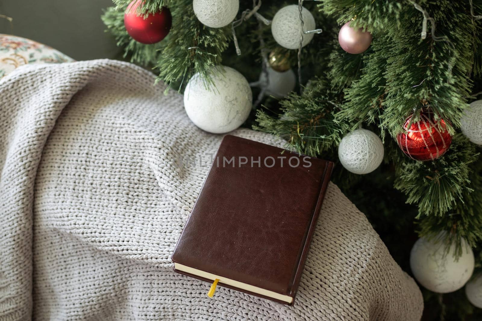 Christmas background with blank notebook, fir branches, decorations and gift boxes. Space for text. Top view. Christmas to-do list or wish list by Andelov13