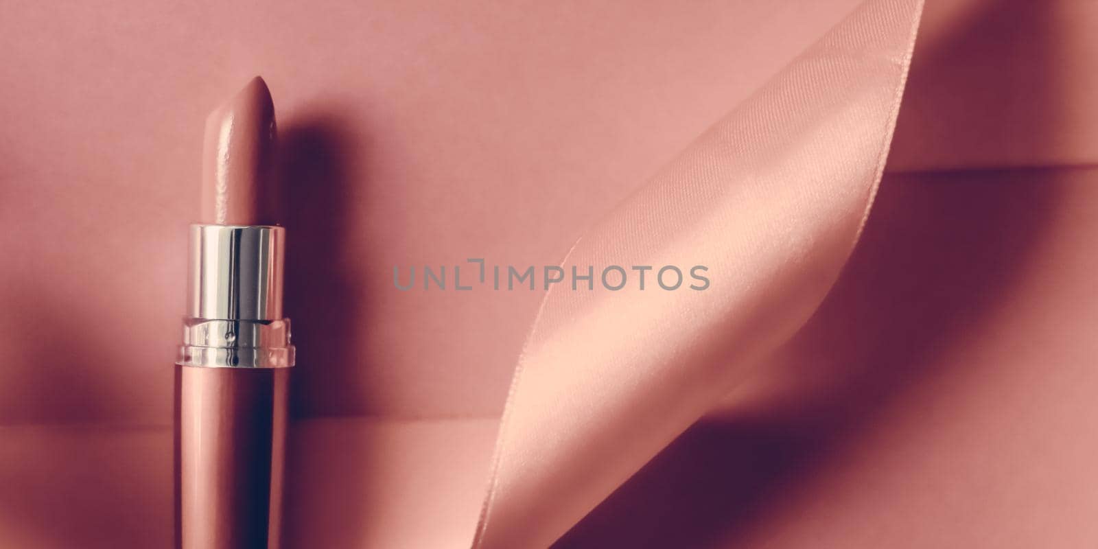 Cosmetic branding, glamour lip gloss and shopping sale concept - Luxury lipstick and silk ribbon on blush pink holiday background, make-up and cosmetics flatlay for beauty brand product design