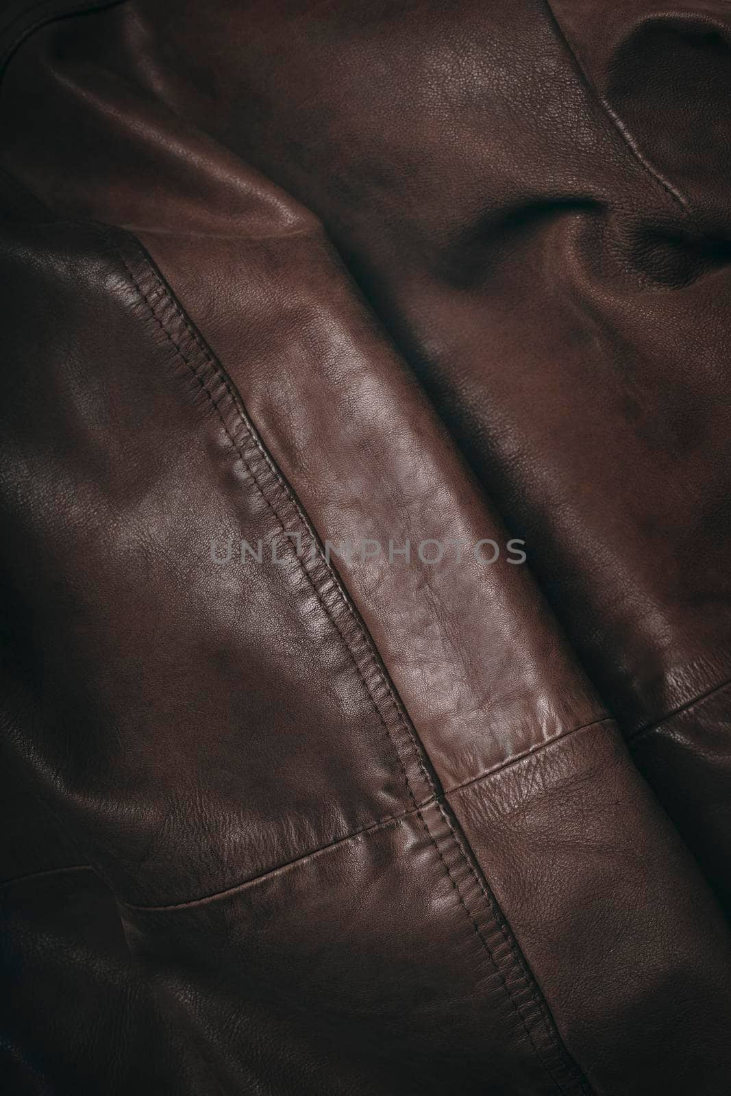 Brown leather material. Highly detailed closeup of leather texture. Cool background. by creativebird