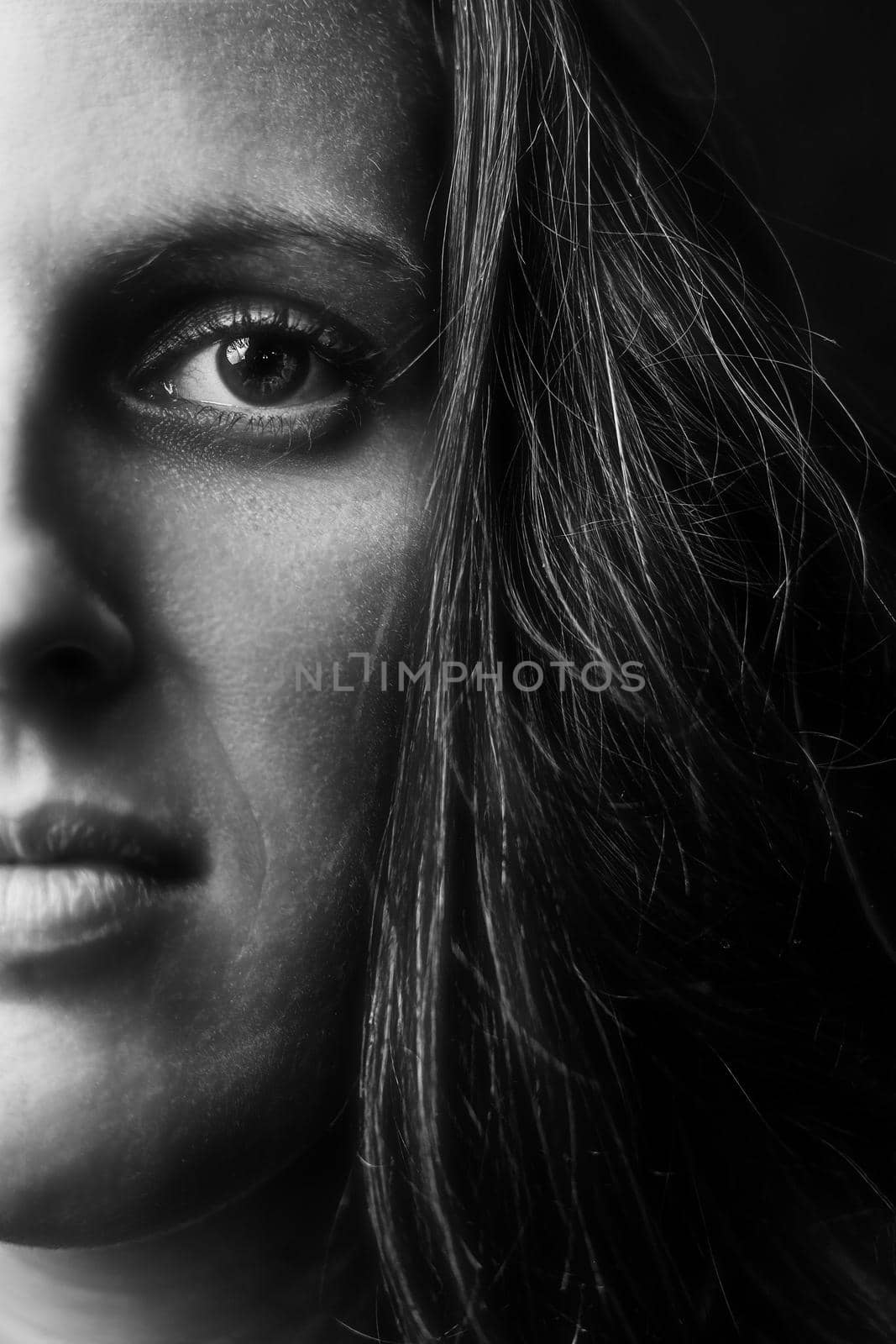 Creative close-up portrait of a pretty young girl, black background