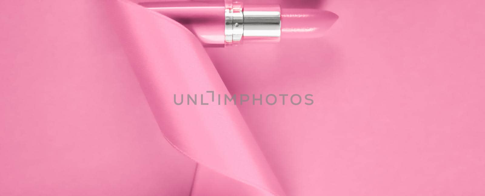 Cosmetic branding, glamour lip gloss and shopping sale concept - Luxury lipstick and silk ribbon on pink holiday background, make-up and cosmetics flatlay for beauty brand product design