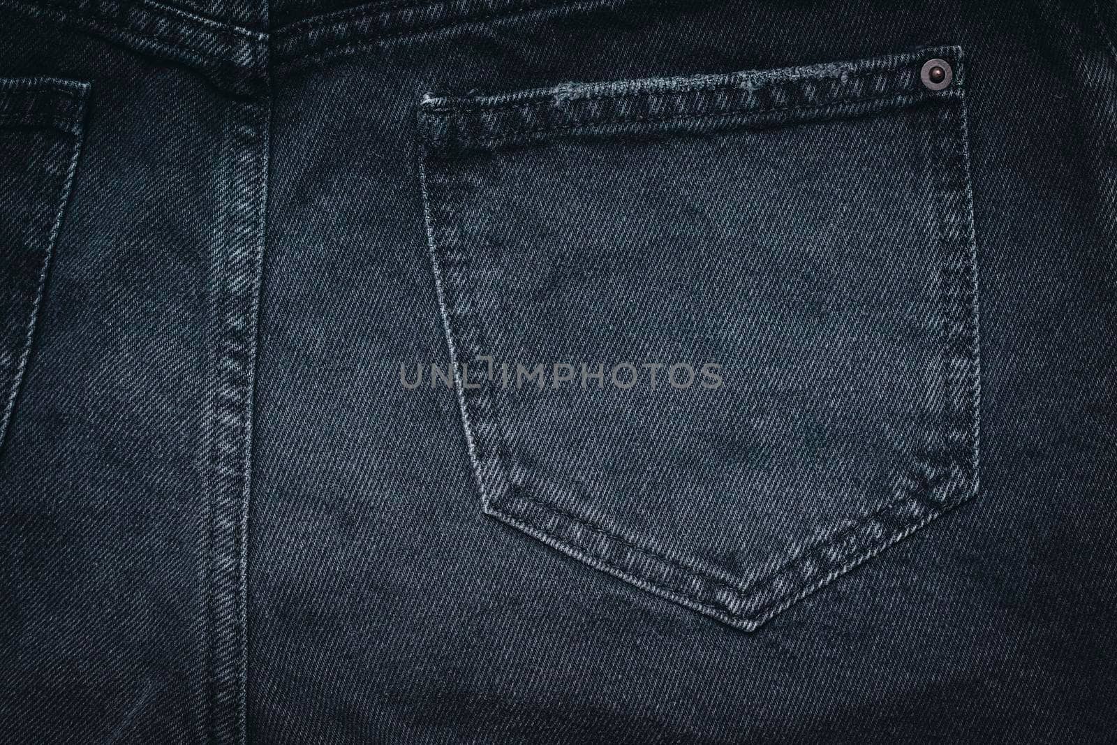 Jeans texture with pocket. Highly detailed closeup of black jeans. Cool background. by creativebird