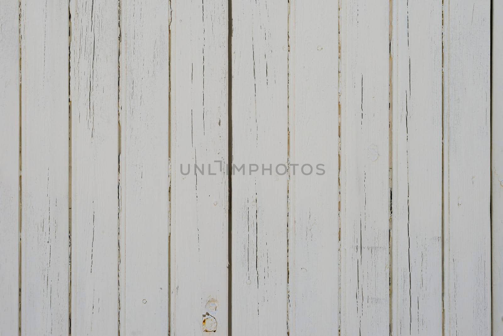 Wooden strips placed vertically and painted white. Concept for backgrounds and textures.