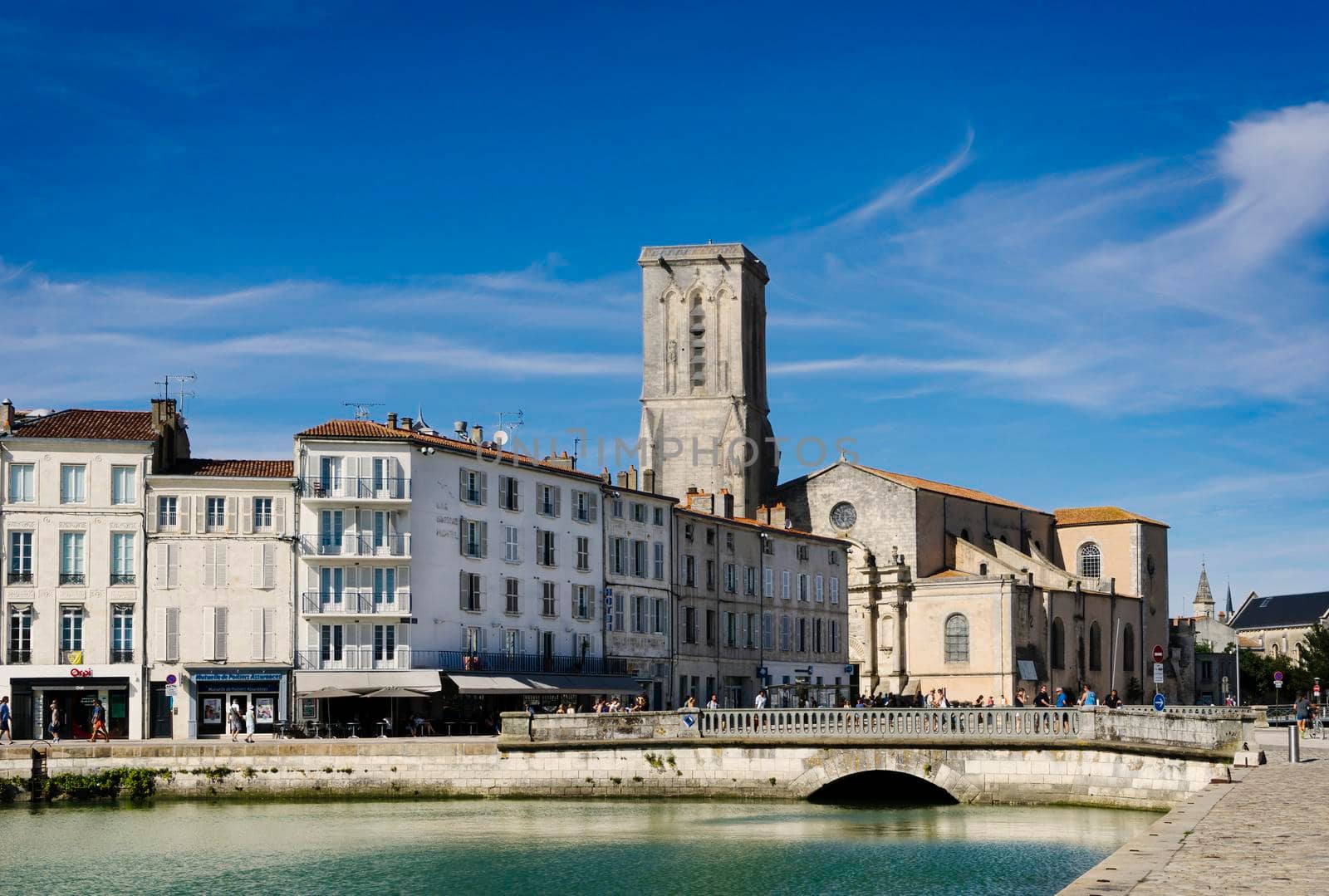 View of the French city of La Rochelle with the Saint Saviour Church in the background with blue sky and sunny summer day.