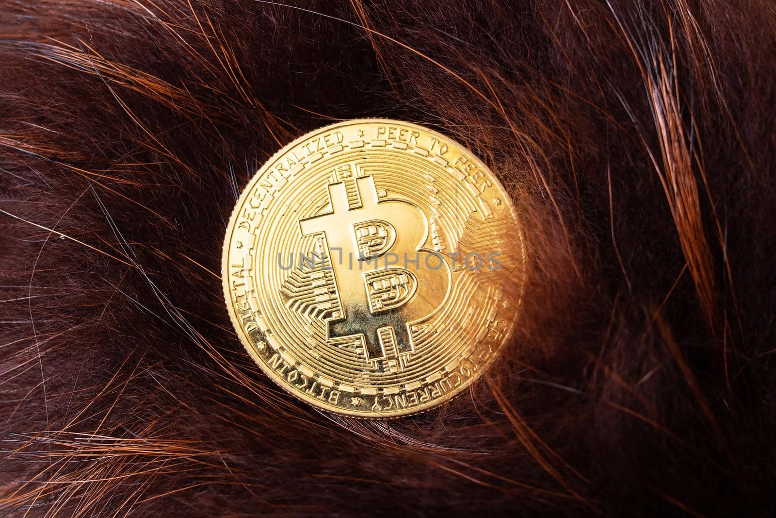 Bitcoin coin on the background of brown pile close up