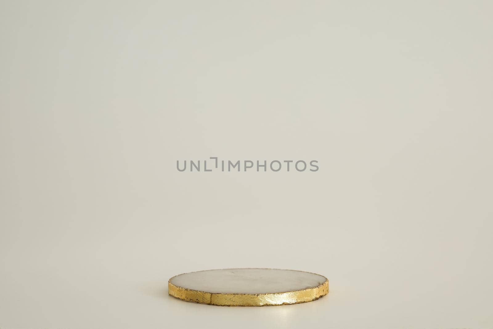 Marble podium with gold on the white background. Podium for product, cosmetic presentation. Creative mock up. Pedestal or platform for beauty products. Minimalist design