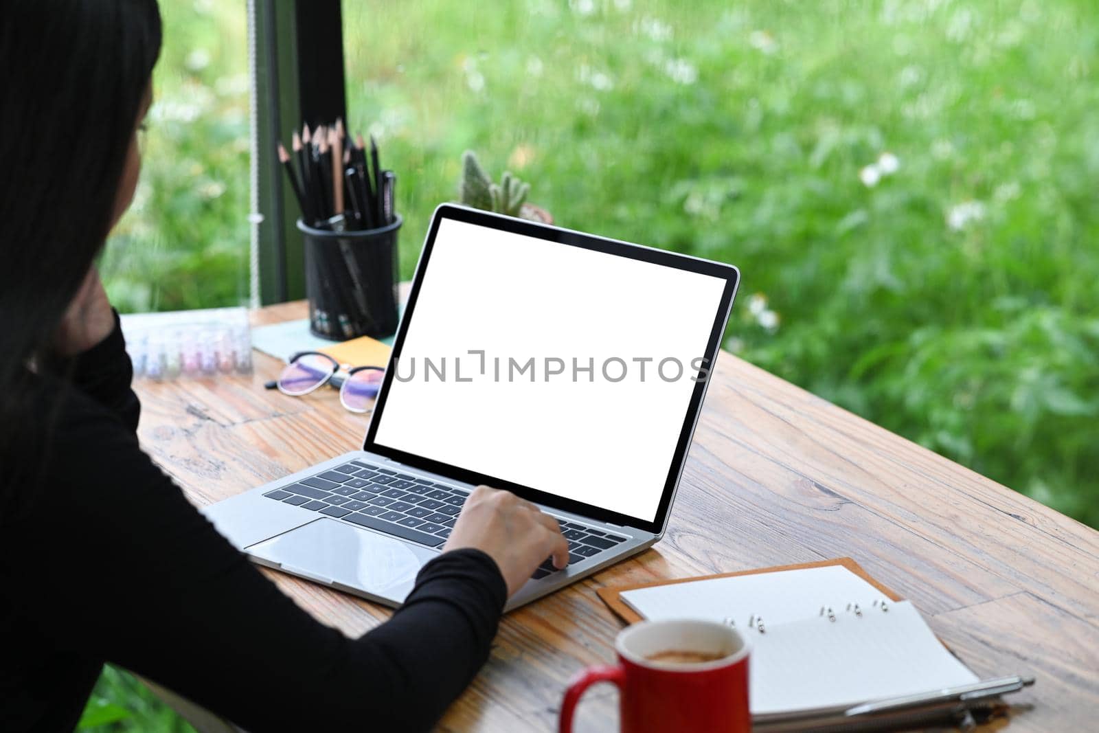 Peaceful female designer working with laptop computer at office.