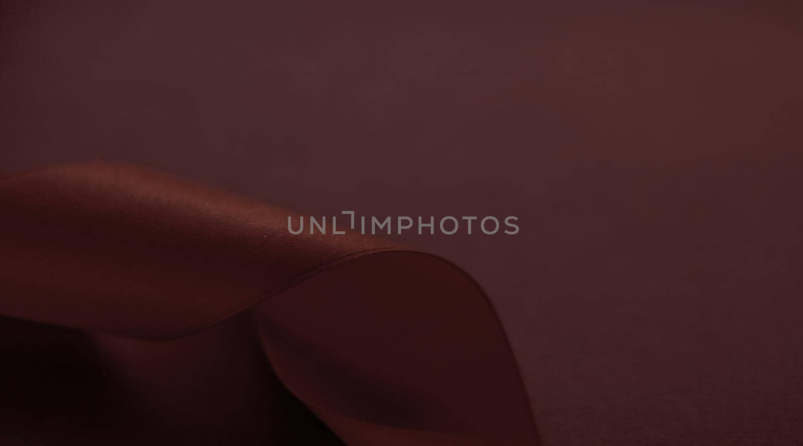 Branding, holidays and luxe brands concept - Abstract silk ribbon on chocolate background, exclusive luxury brand design for holiday sale product promotion and glamour art invitation card backdrop