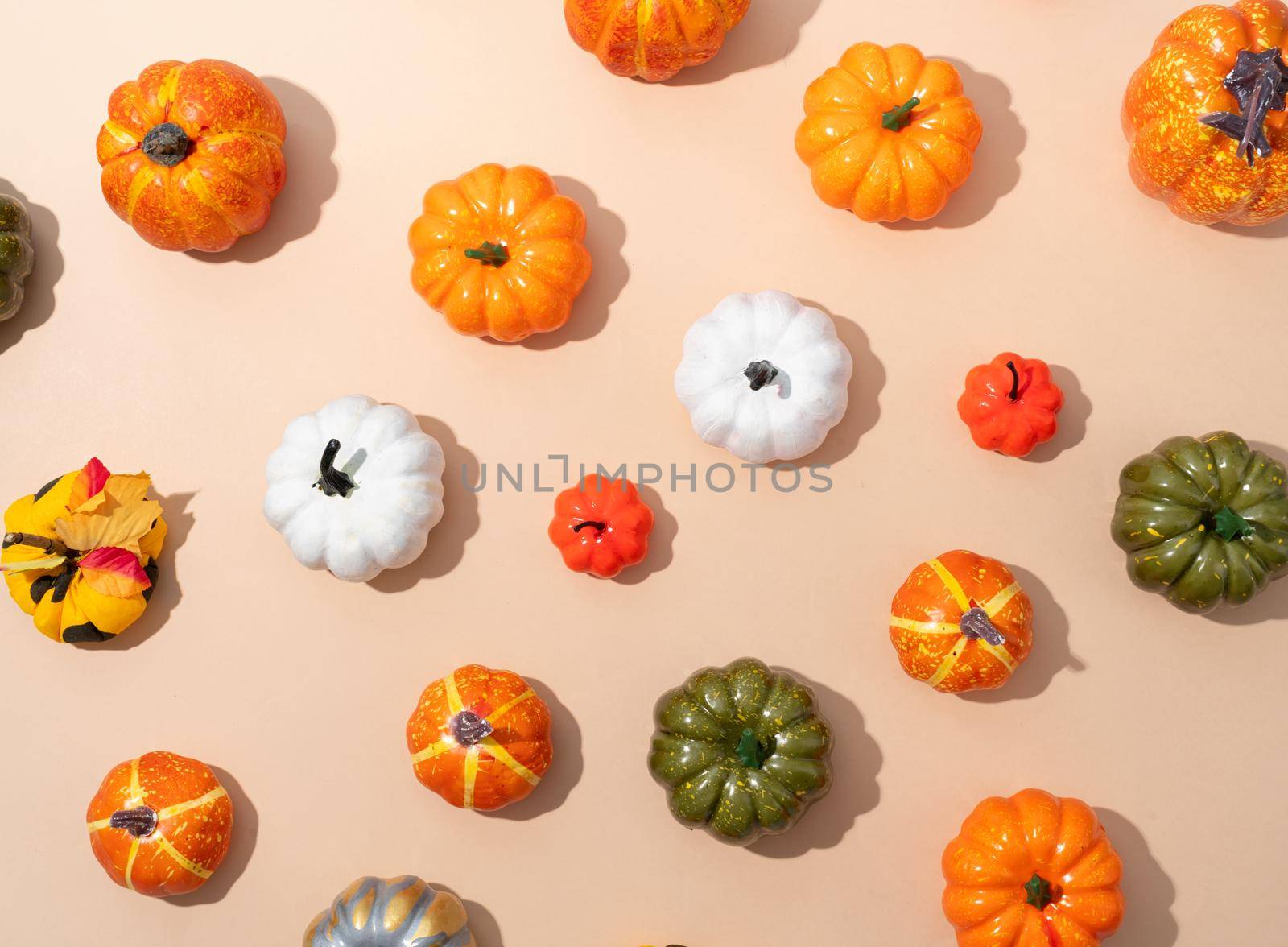 Pumpkin pattern, decorative pumpkins on orange background top view. Autumn, fall, halloween concept. Trend shadow.
