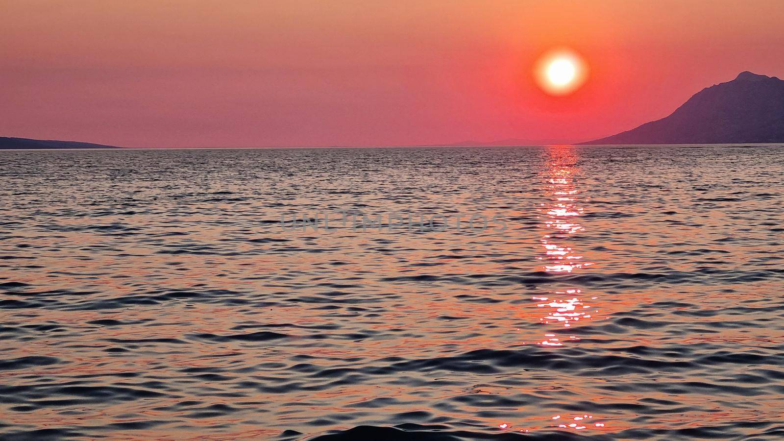 Beautiful red sunset over the Adriatic sea. Makarska Riviera-Biokovo, Dalmatia, Croatia, Europe.