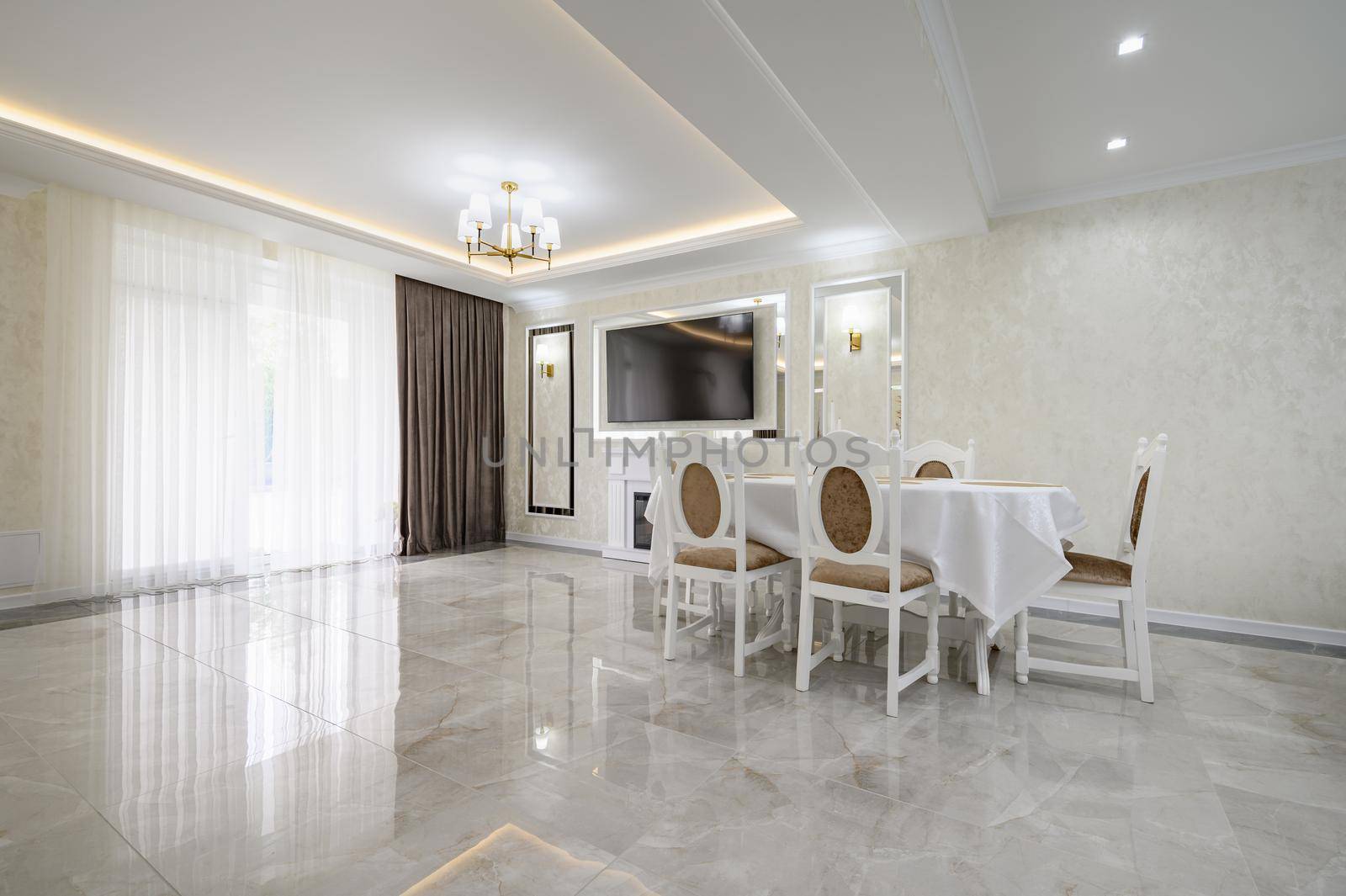 Luxurious white large home kitchen with dining table and marble floor, lots of copyspace