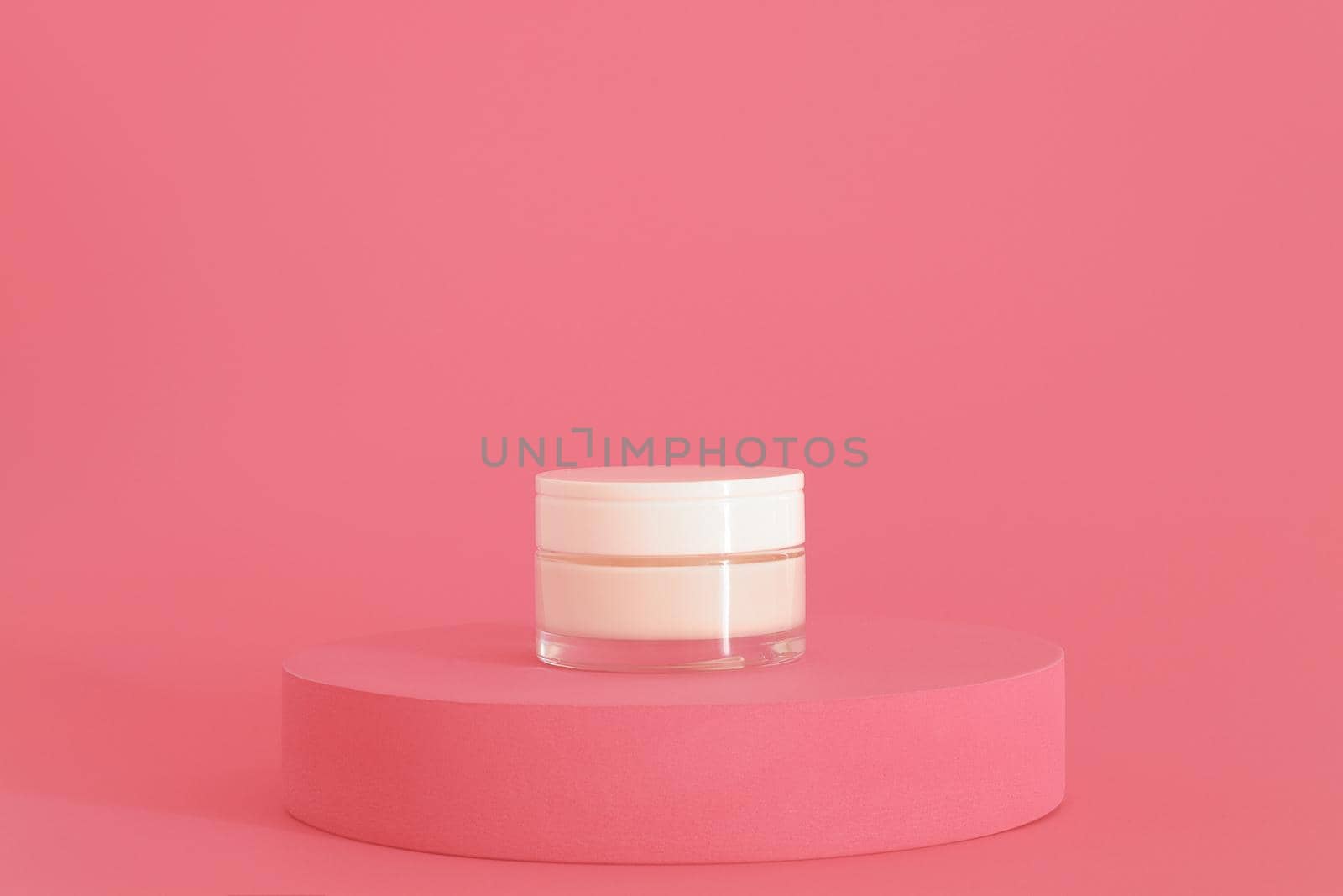 Cosmetic cream packaging standing on pink podium. Cream presentation on the pink background. Mockup. by creativebird