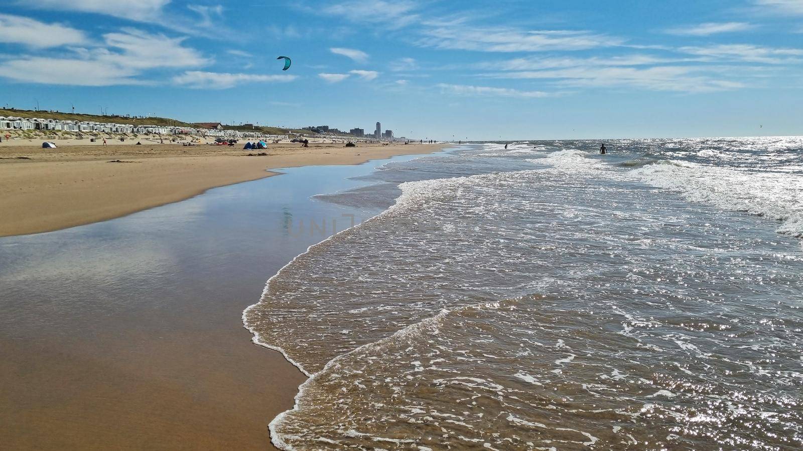 View to the North Sea city beach on a sunny summer weekend. Typical pavilions. Zandvoort, Netherlands by anytka