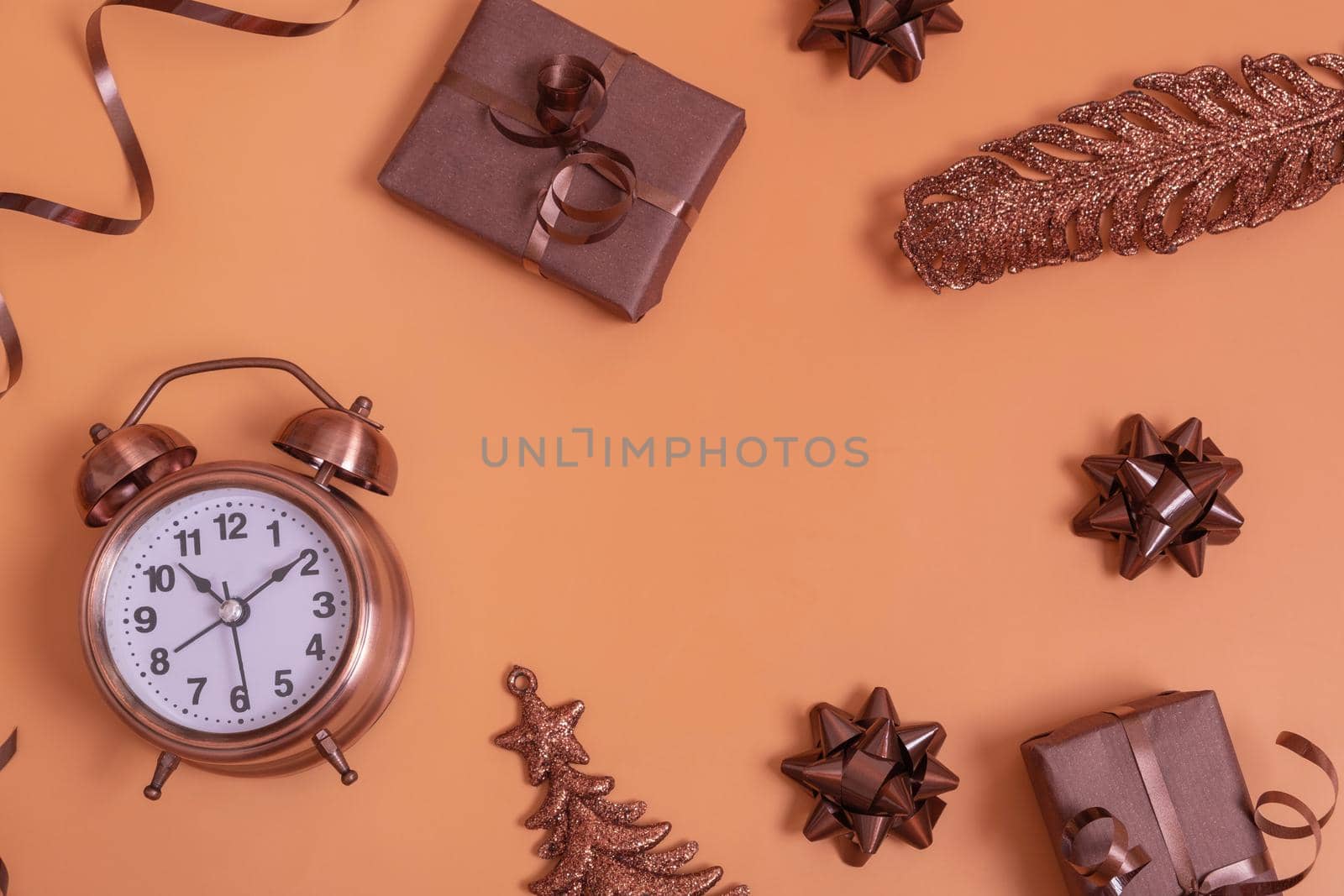 Flat lay alarm clock and gift boxes on color background top view with copy space by ssvimaliss