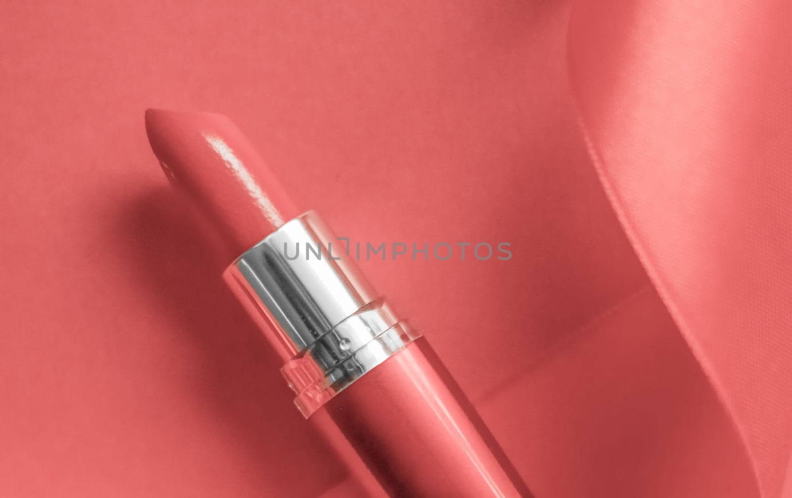 Cosmetic branding, glamour lip gloss and shopping sale concept - Luxury lipstick and silk ribbon on coral holiday background, make-up and cosmetics flatlay for beauty brand product design