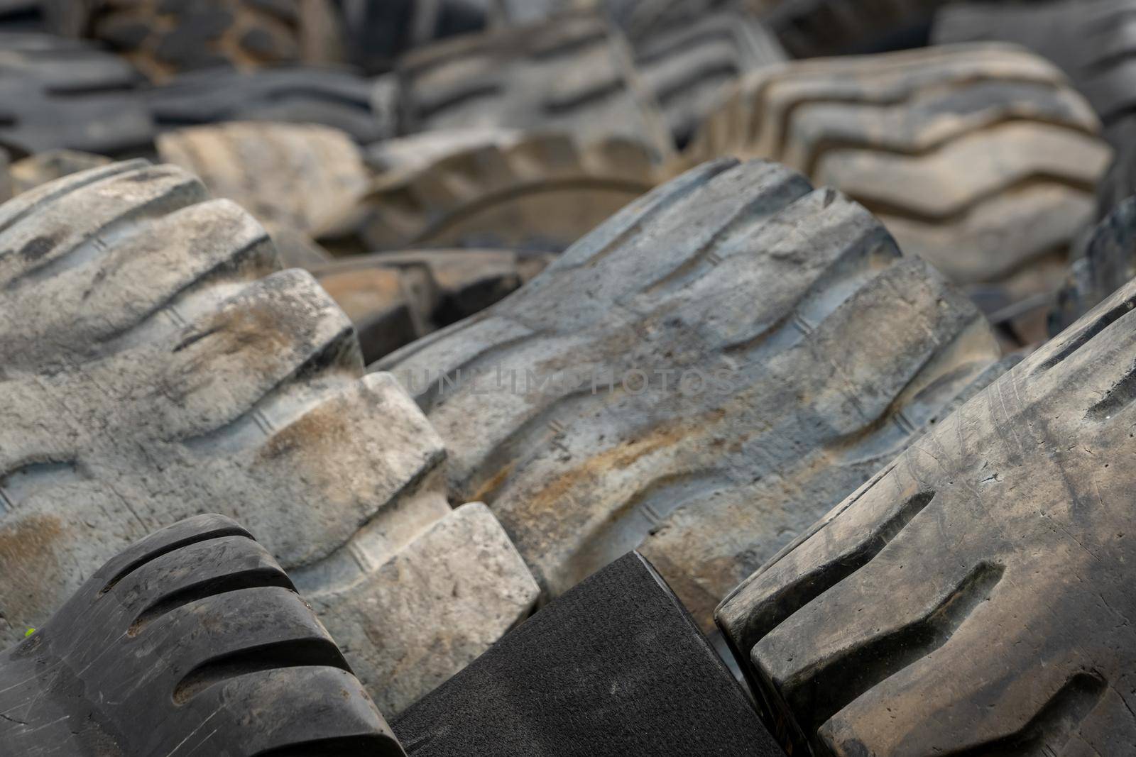 Closeup used truck tires. Old tyres waste for recycle or for landfill. Black rubber tire of truck. Pile of used tires at recycling yard. Material for landfill. Recycled tires. disposal waste tires. by Fahroni