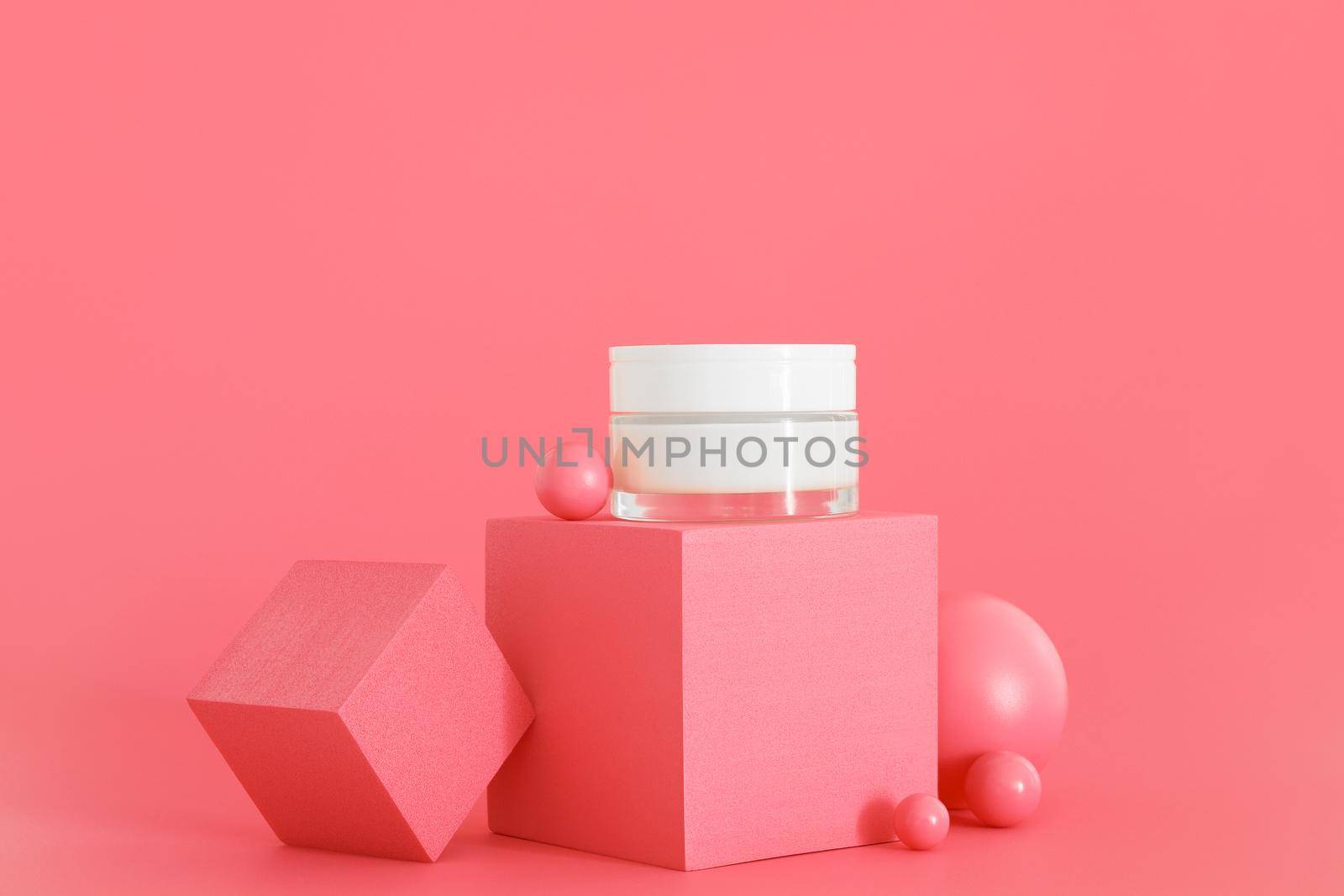 White unbranded cosmetic cream jar standing on pink podium. Skin care product presentation on the pink background. Trendy mockup. Skincare, beauty and spa. by creativebird