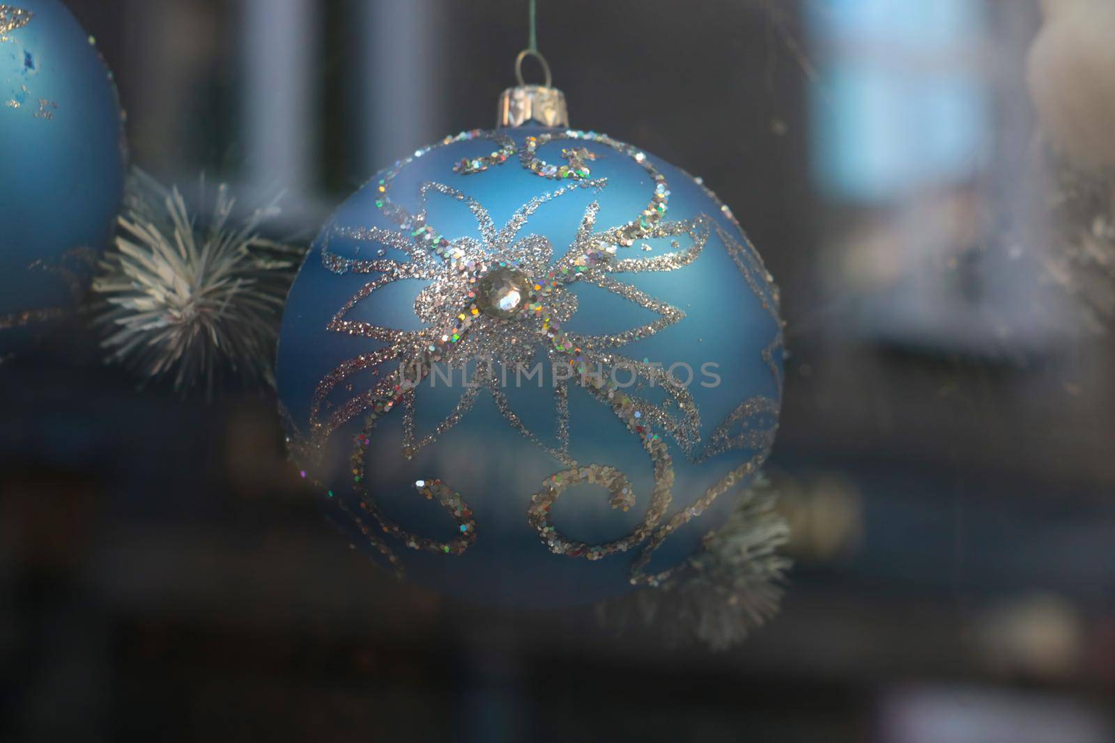 Close-up on a beautiful bright ball that hangs on a spruce. Preparing for the New Year and Christmas. Decorations