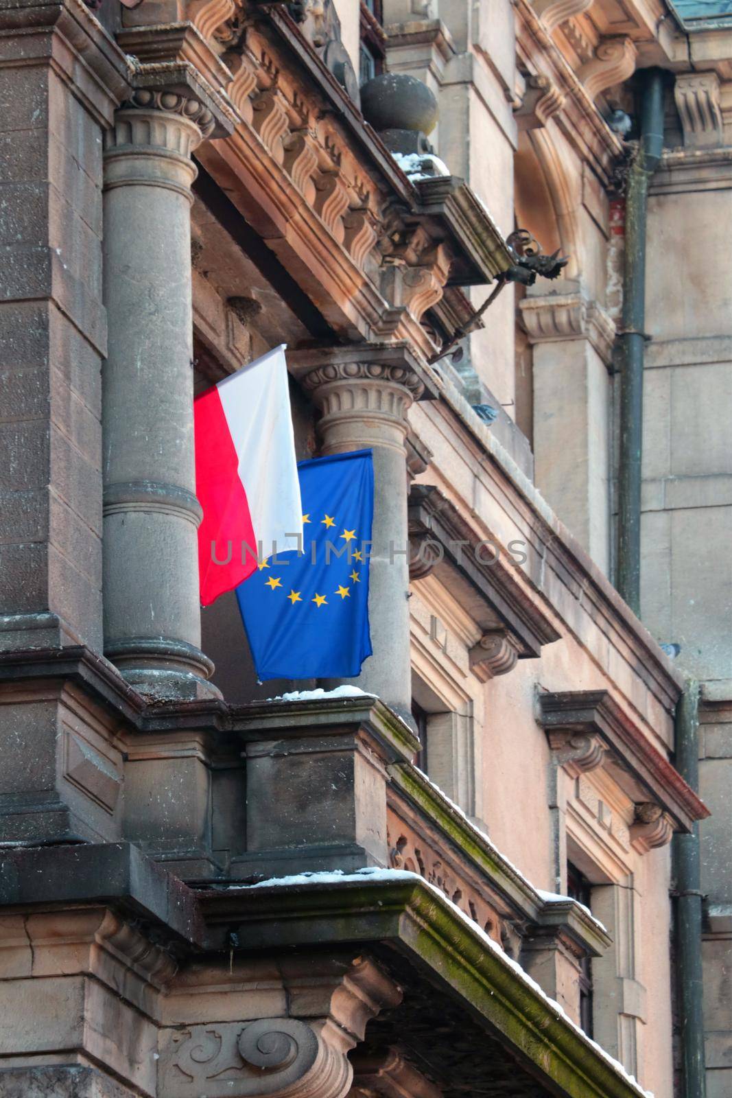The flags of Poland and the European Union are hung on the building. by kip02kas