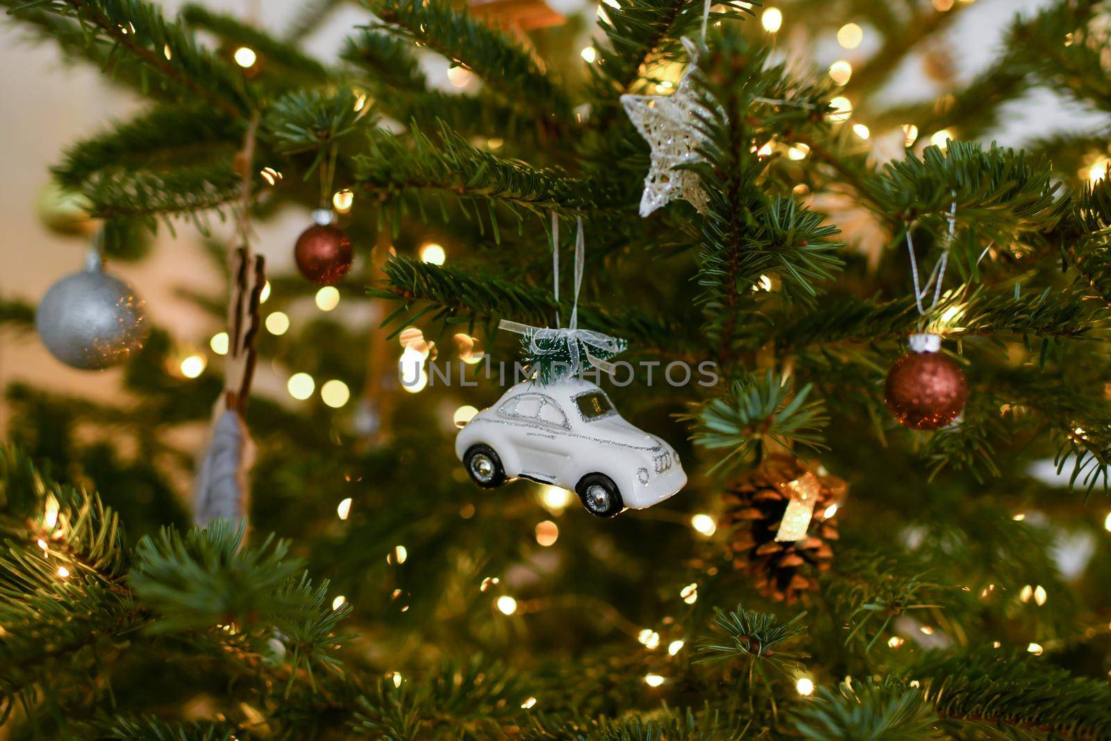 White car and toys hanging on a Christmas tree