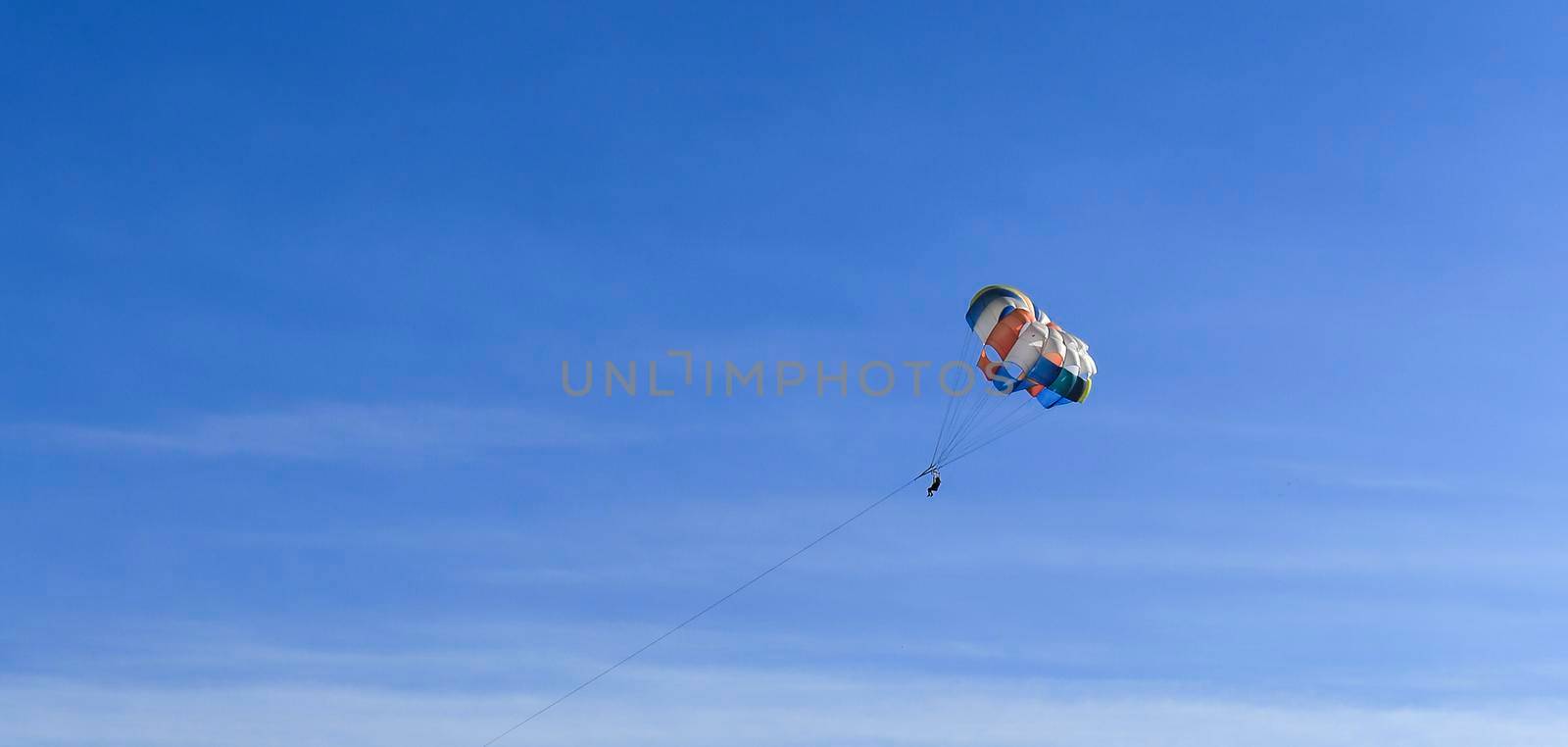 Benidorm, Alicante, Spain- September 11, 2022: People parasailing in Santa Pola on a sunny day of summer