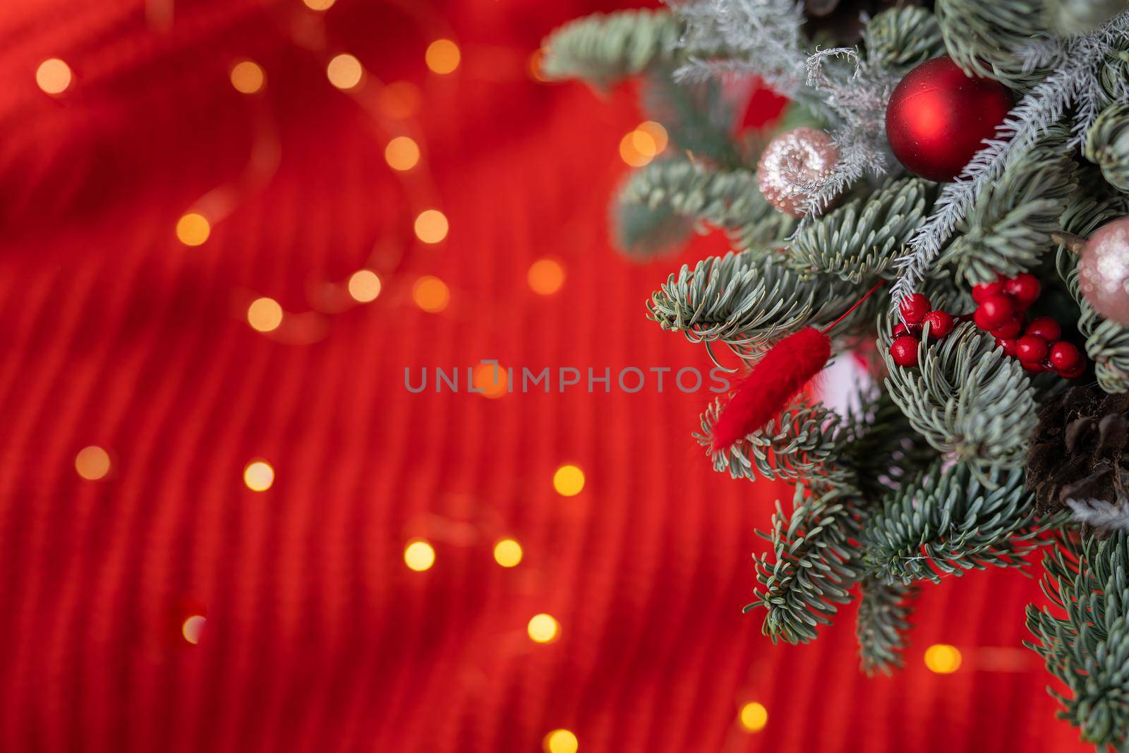 Decorated Christmas tree with candies and lights on a blurred background. Preparing for Christmas and New Year 2023