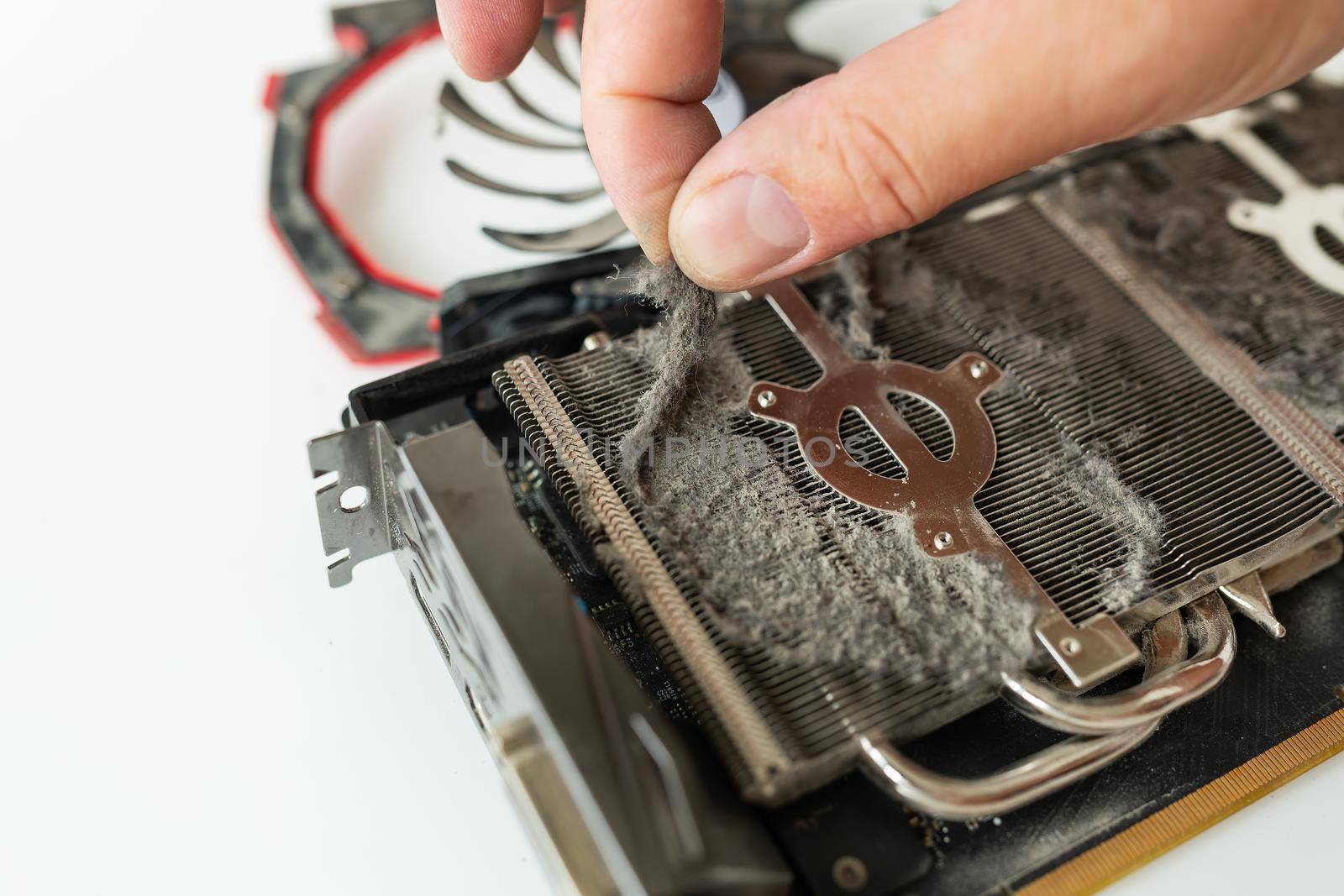 Cleaning the video card of the computer from dust. Computer maintenance and care. A professional in his field