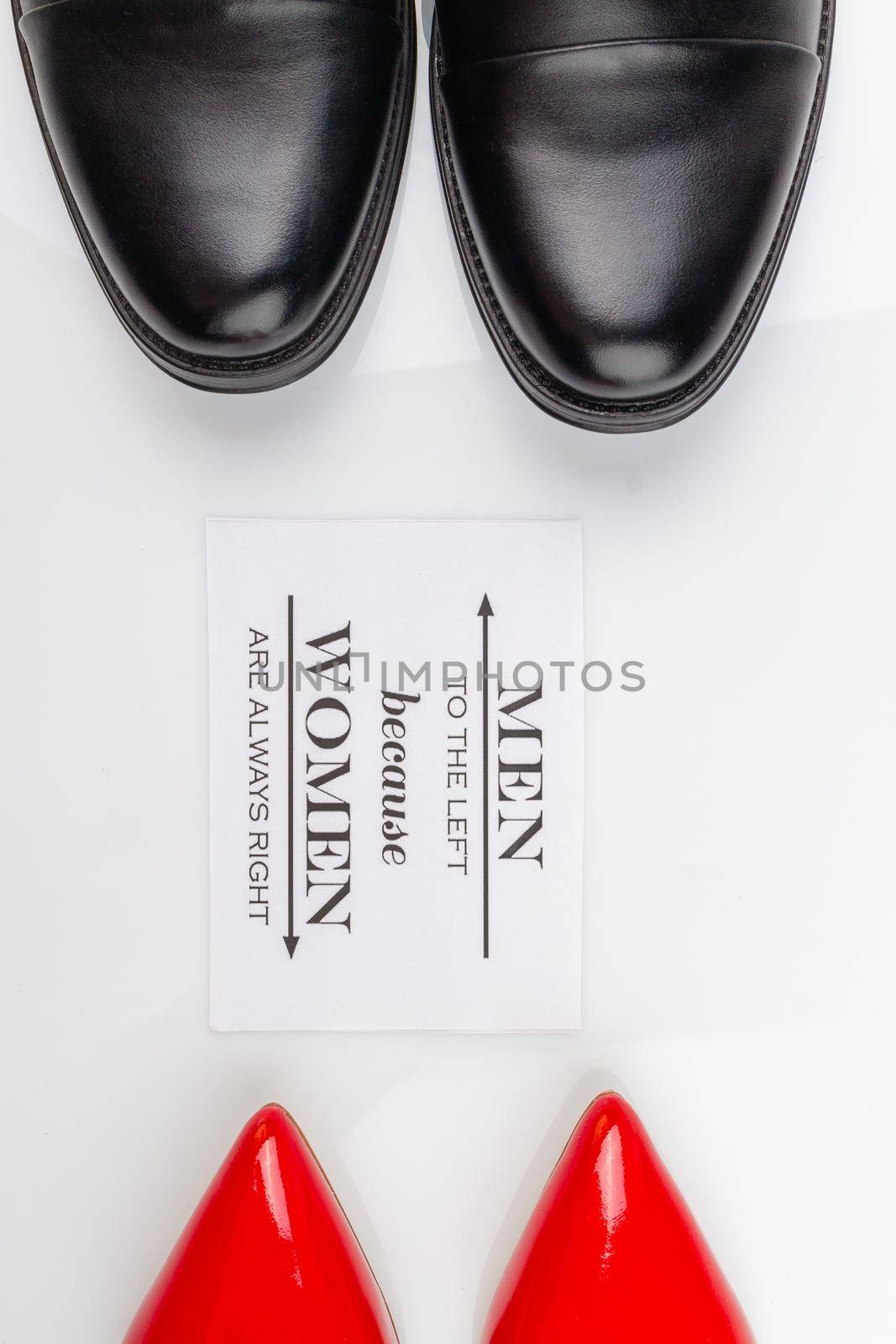 Vertical shot of mens and womens shoes on white surface. by super_picture
