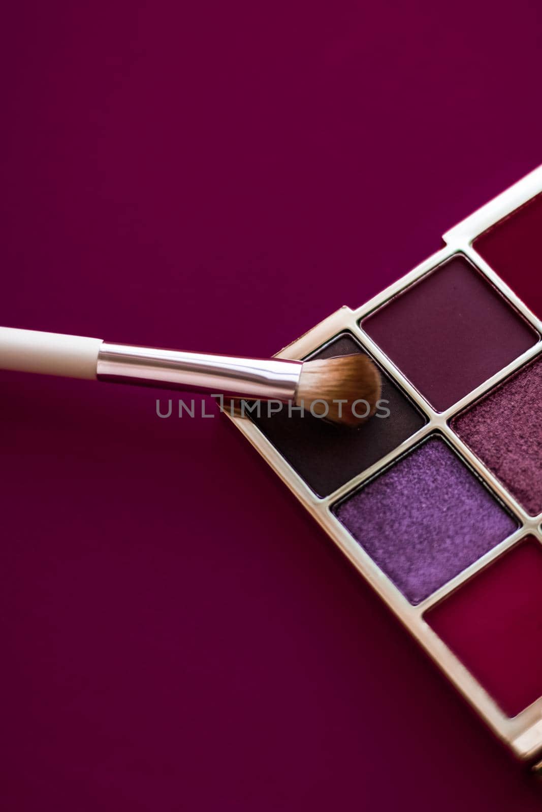 Cosmetic branding, mua and girly concept - Eyeshadow palette and make-up brush on wine background, eye shadows cosmetics product for luxury beauty brand promotion and holiday fashion blog design