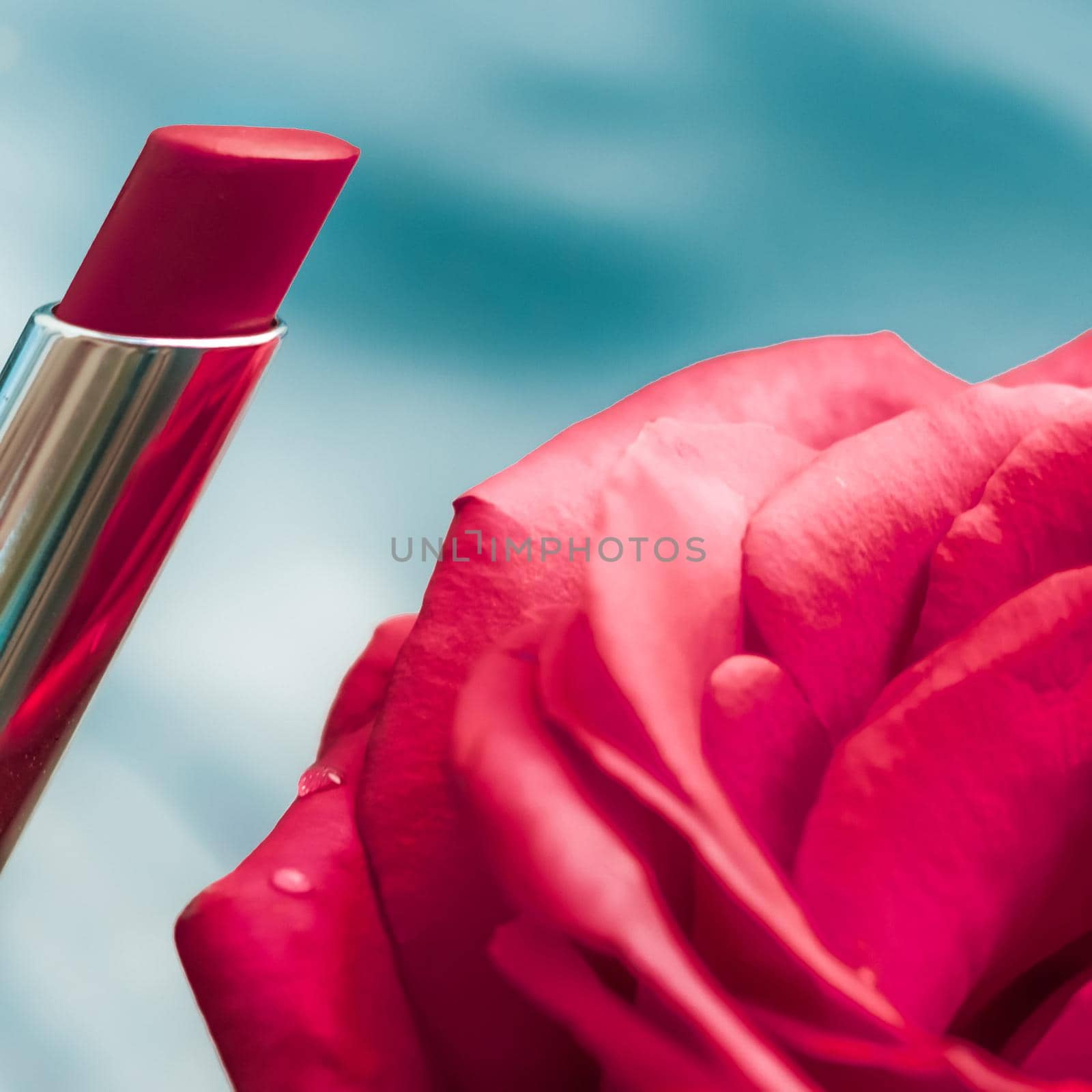 Cosmetic branding, luxe and fashion concept - Red lipstick and rose flower on liquid background, waterproof glamour make-up and lip gloss cosmetics product for luxury beauty brand holiday design