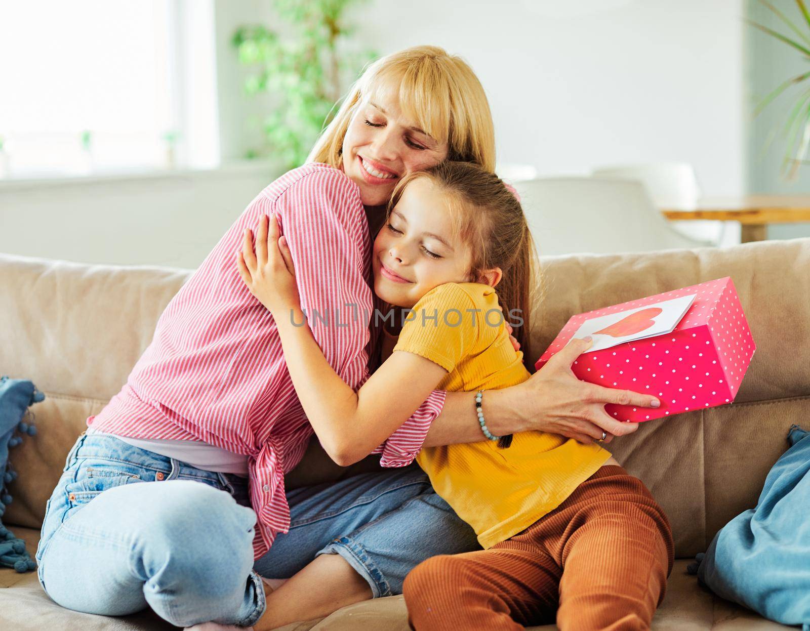 Daughter surprises her mother with present on mother's day or birthday at home