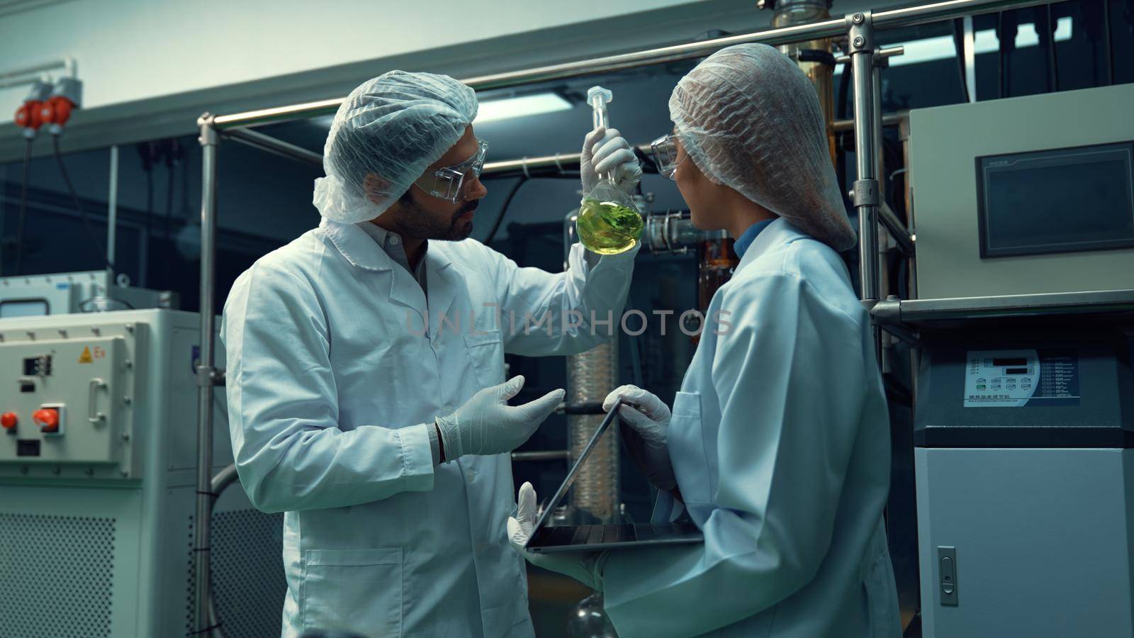 Two scientist in professional uniform working in laboratory by biancoblue