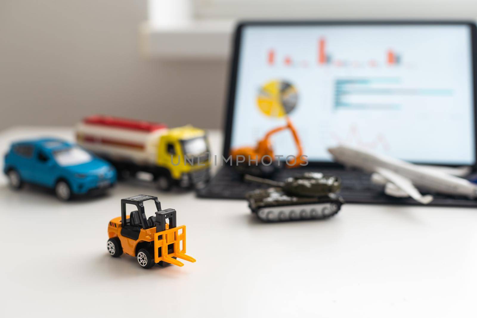 Tablet, a set of toy vehicles.