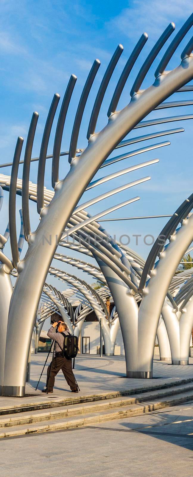 Dubai, UAE - 09.24.2021 Photographer taking pictures of decorative installations at plaza of The View at The Palm.