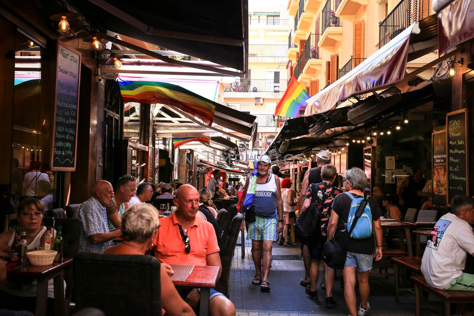 Benidorm, Alicante, Spain- September 10, 2022: Bars and terraces of typical spanish food full of people in the old town of Benidorm