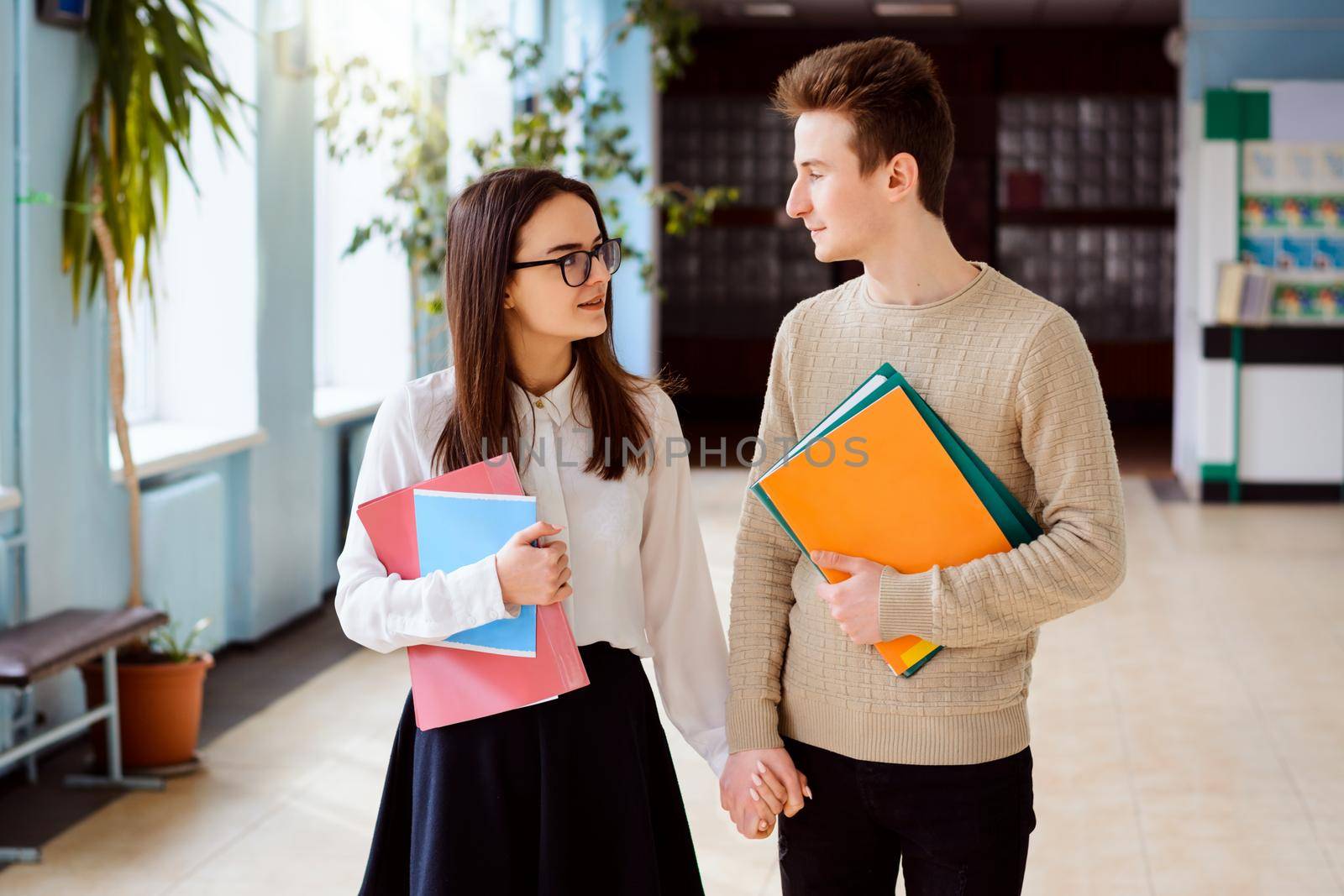 Male and female students in love studying together in the conventional college