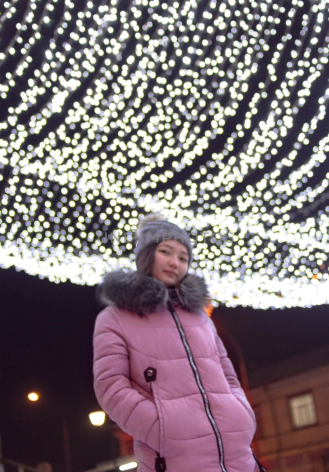 Woman on central downtown with christmas lights, sky festive illumination shine and glow, defocus image by Clara_Sh